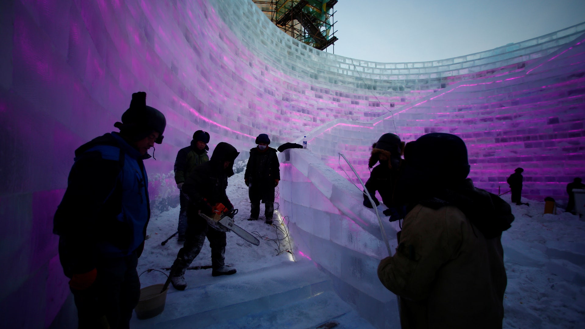 Artists and workers prepare an ice sculpture in China.