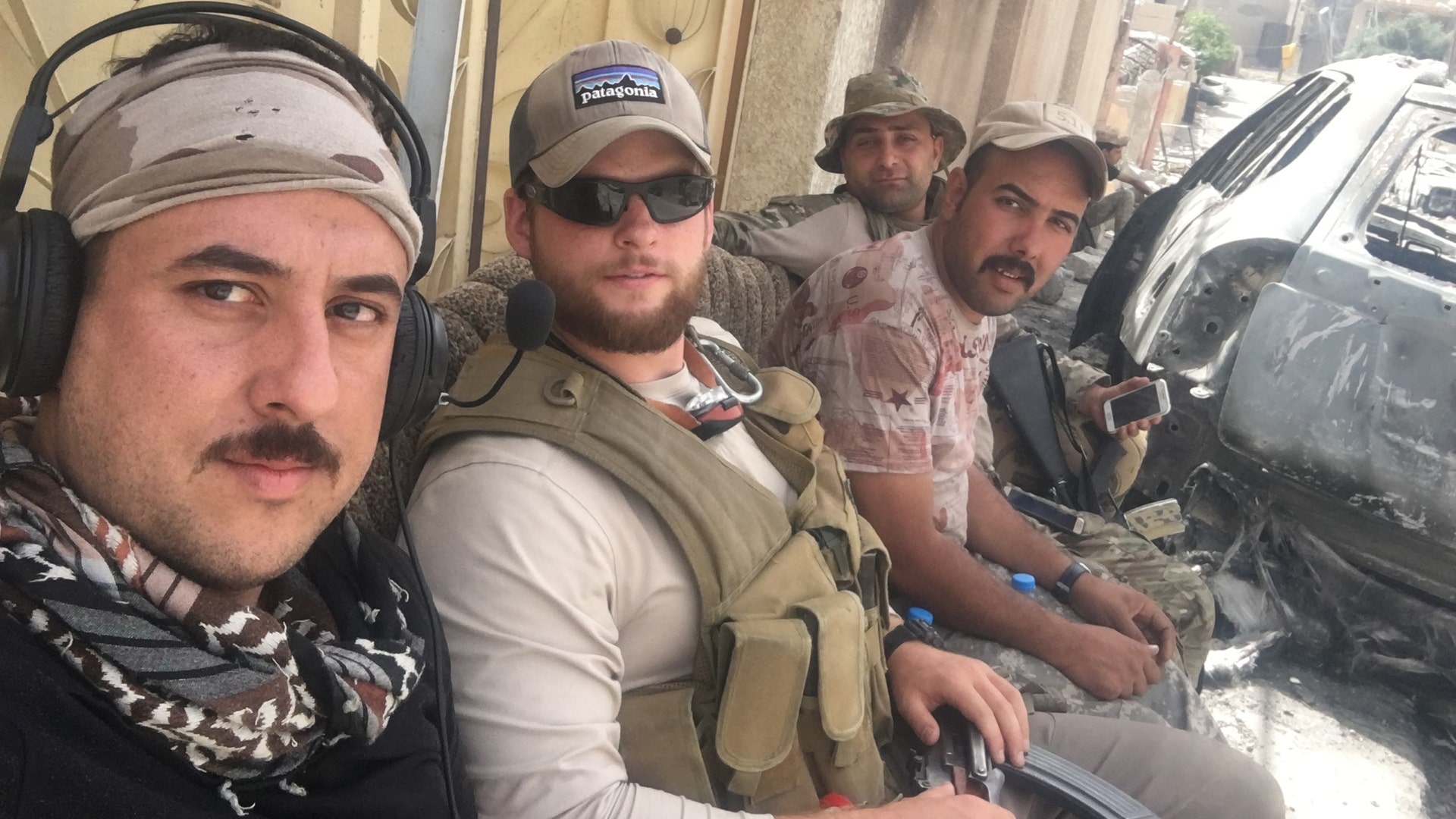 Ephraim Mattos waiting for a ride to the front lines with a few Iraqi soldiers, May 2017