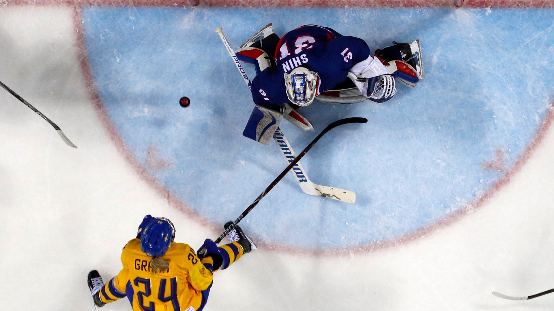 Erika Grahm of Sweden in action with goalkeeper Shin So-jung of Korea at the Pyeongchang 2018 Winter Olympics 
