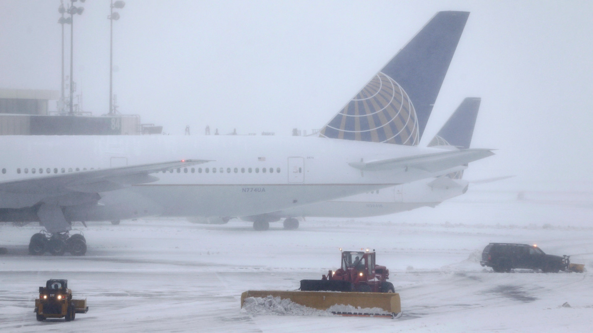 Snowplows work to keep the grounds clear at Newark Liberty International Airport in Newark, NJ.