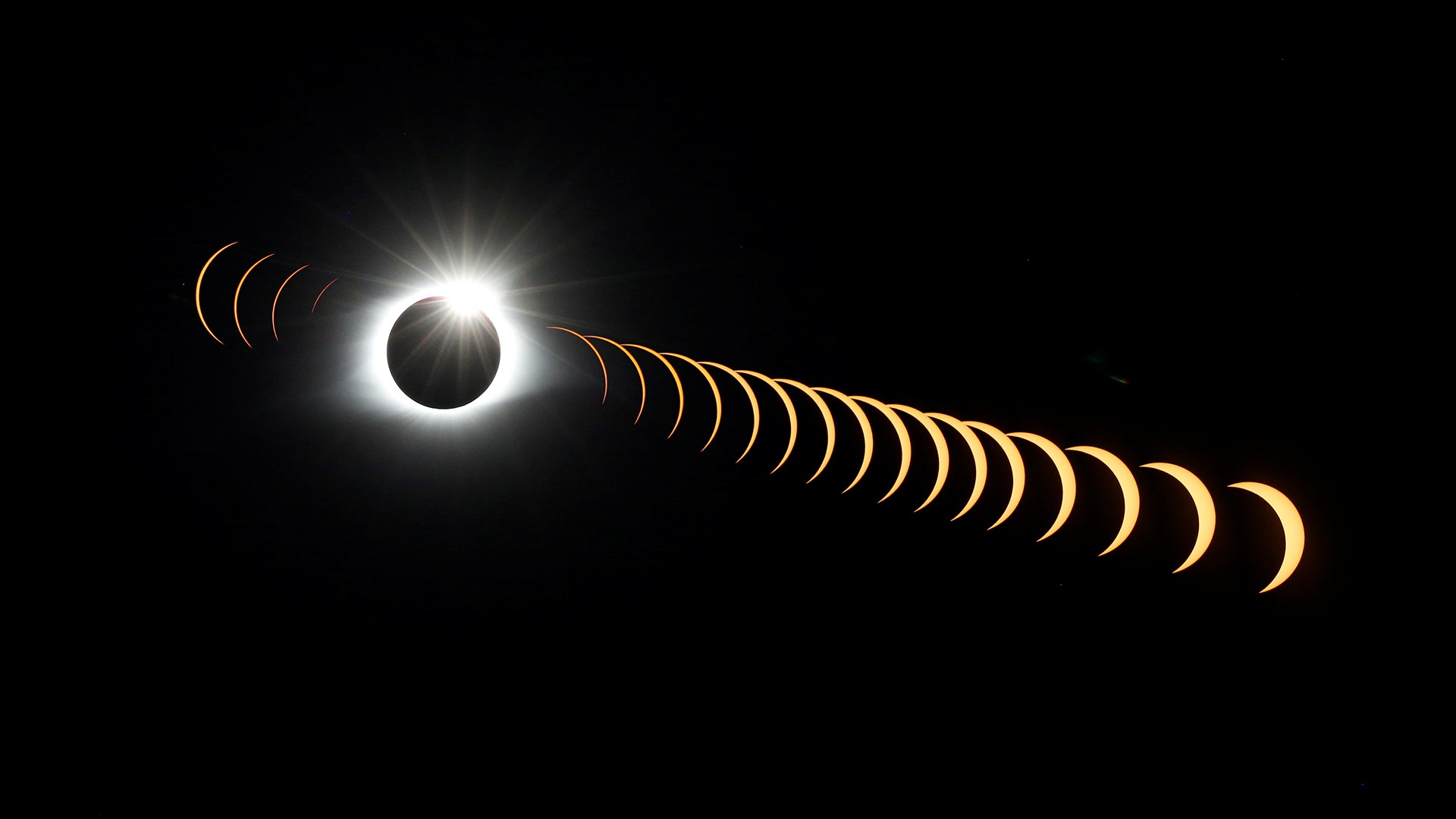 A composite image of 21 separate photographs shows the solar eclipse seen from the Great Smoky Mountains National Park, August 21