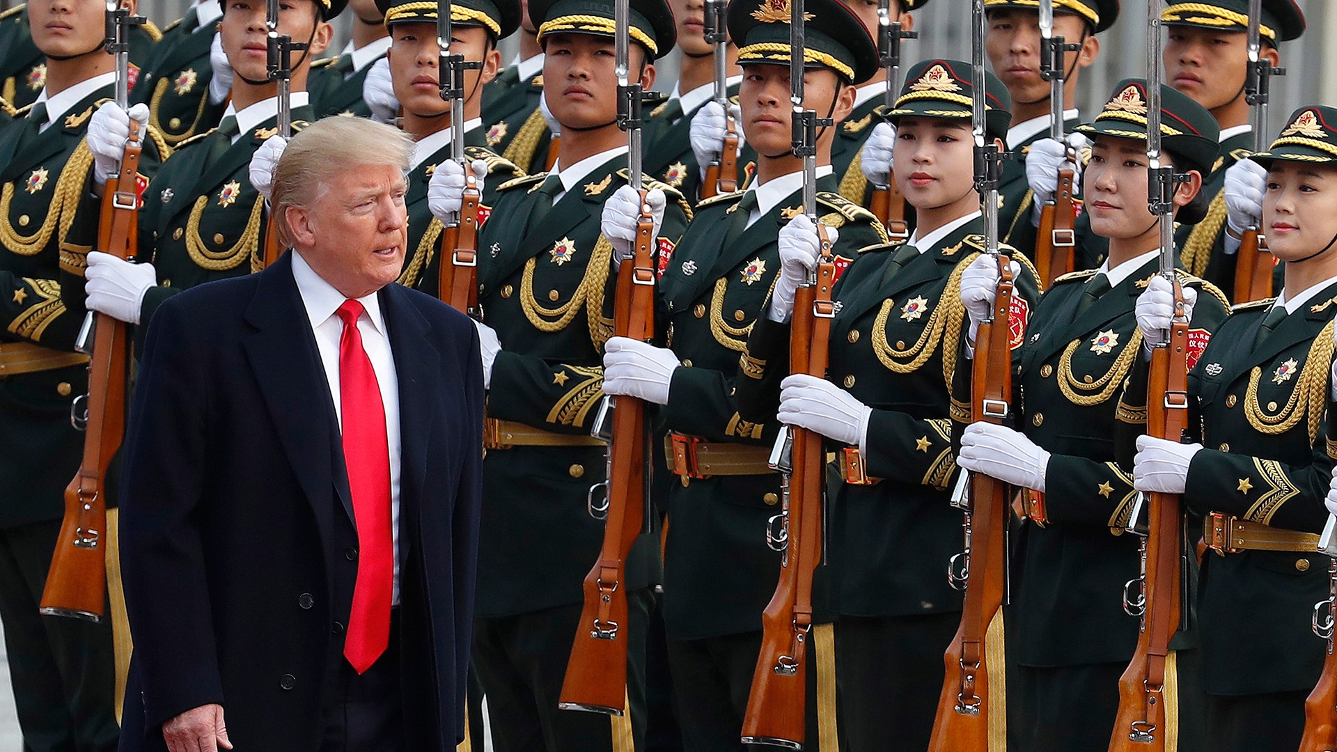 U.S. President Donald Trump reviews an honor guard during a welcome ceremony at the Great Hall of the People in Beijing, November 9