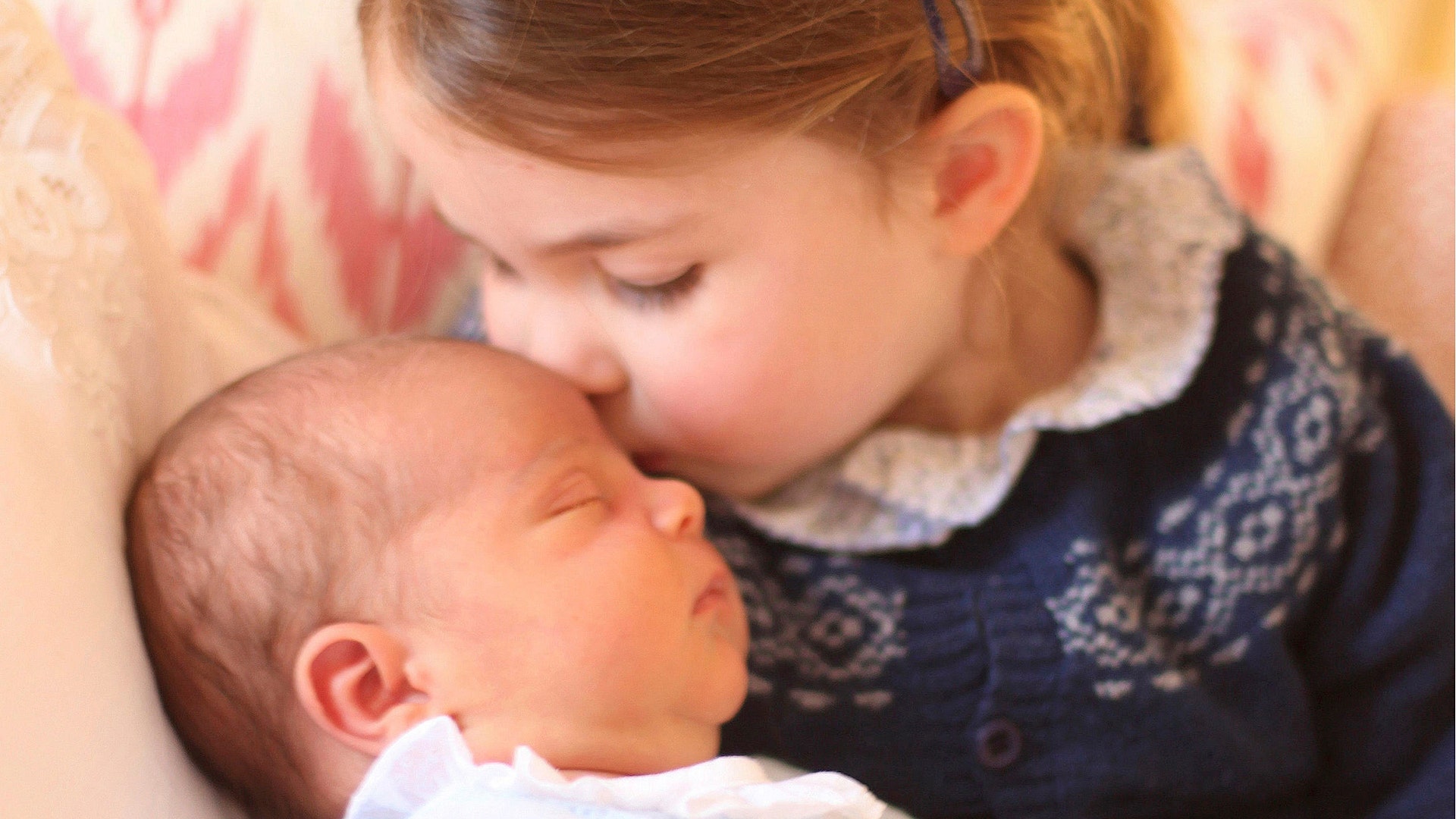 Britain's Princess Charlotte cuddles her brother Prince Louis, on her third birthday, at Kensington Palace, in London, May 2, 2018