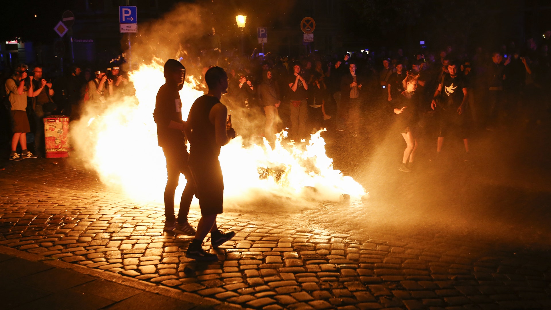 Protesters stand near a burning barricade during the demonstration during the G20 summit in Hamburg, Germany, July 6, 2017