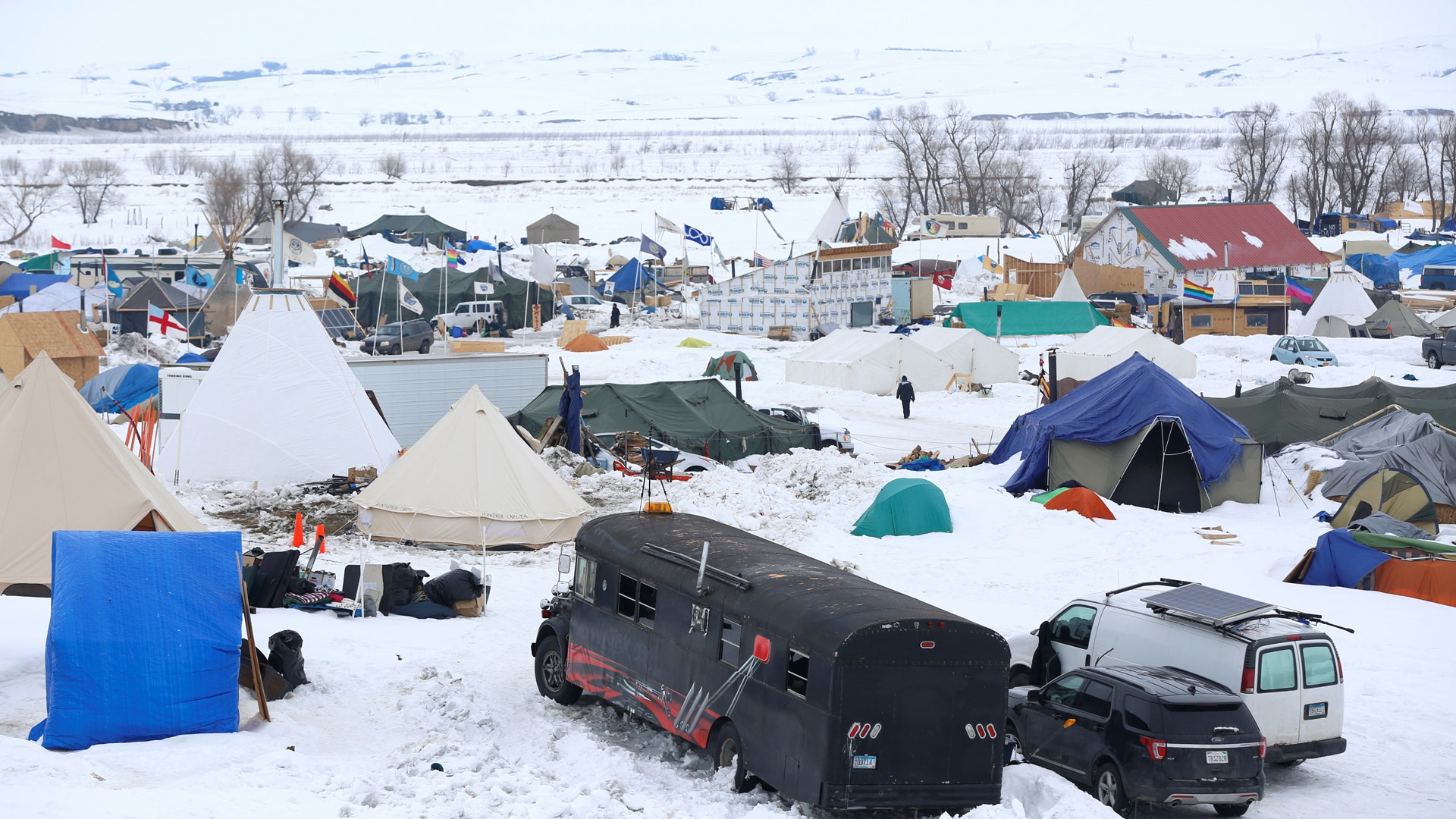 People walk through the Dakota Access Pipeline protest camp on the edge of the Standing Rock Sioux Reservation.