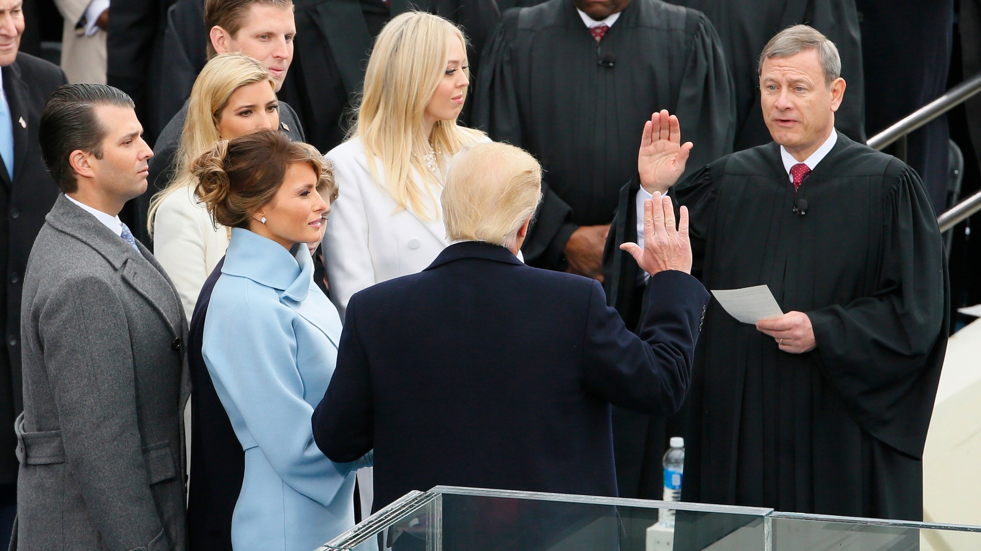 U.S. President Donald Trump takes the oath of office from Supreme Court Chief Justice John Roberts with his wife Melania, and children Barron, Donald Jr, Eric, Ivanka and Tiffany at his side during inauguration ceremonies in Washington.