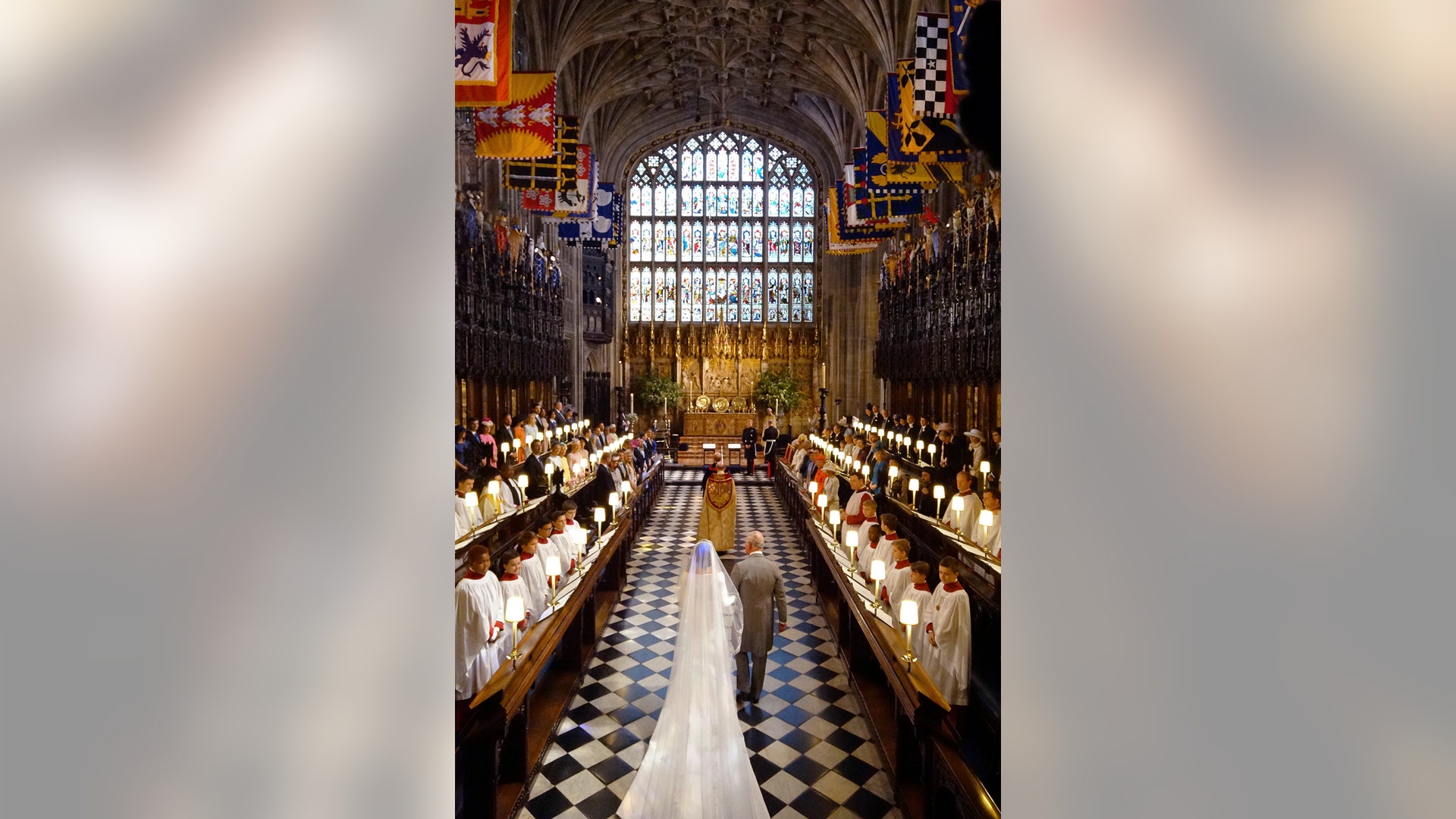 Meghan Markle is walked down the aisle by Prince Charles at St. George's Chapel in Windsor Castle