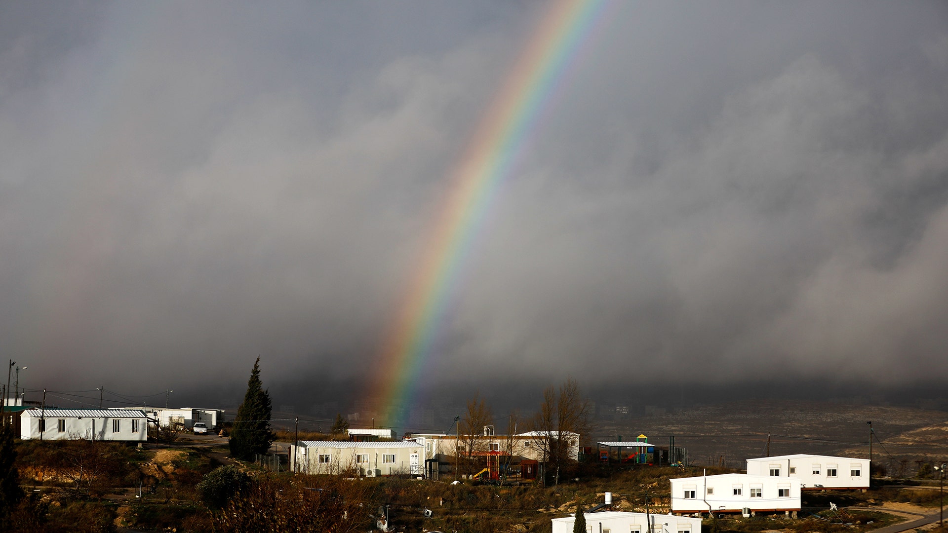 A rainbow is seen over the Israeli settler outpost of Amona in the occupied West Bank.