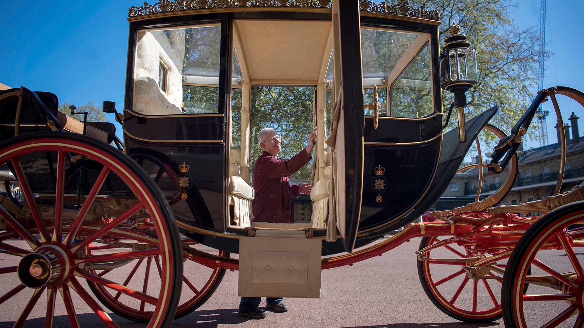 Martin Oates polishes the Scottish State Coach, which will be used in the case of wet weather, for the royal wedding, in London, May 1, 2018