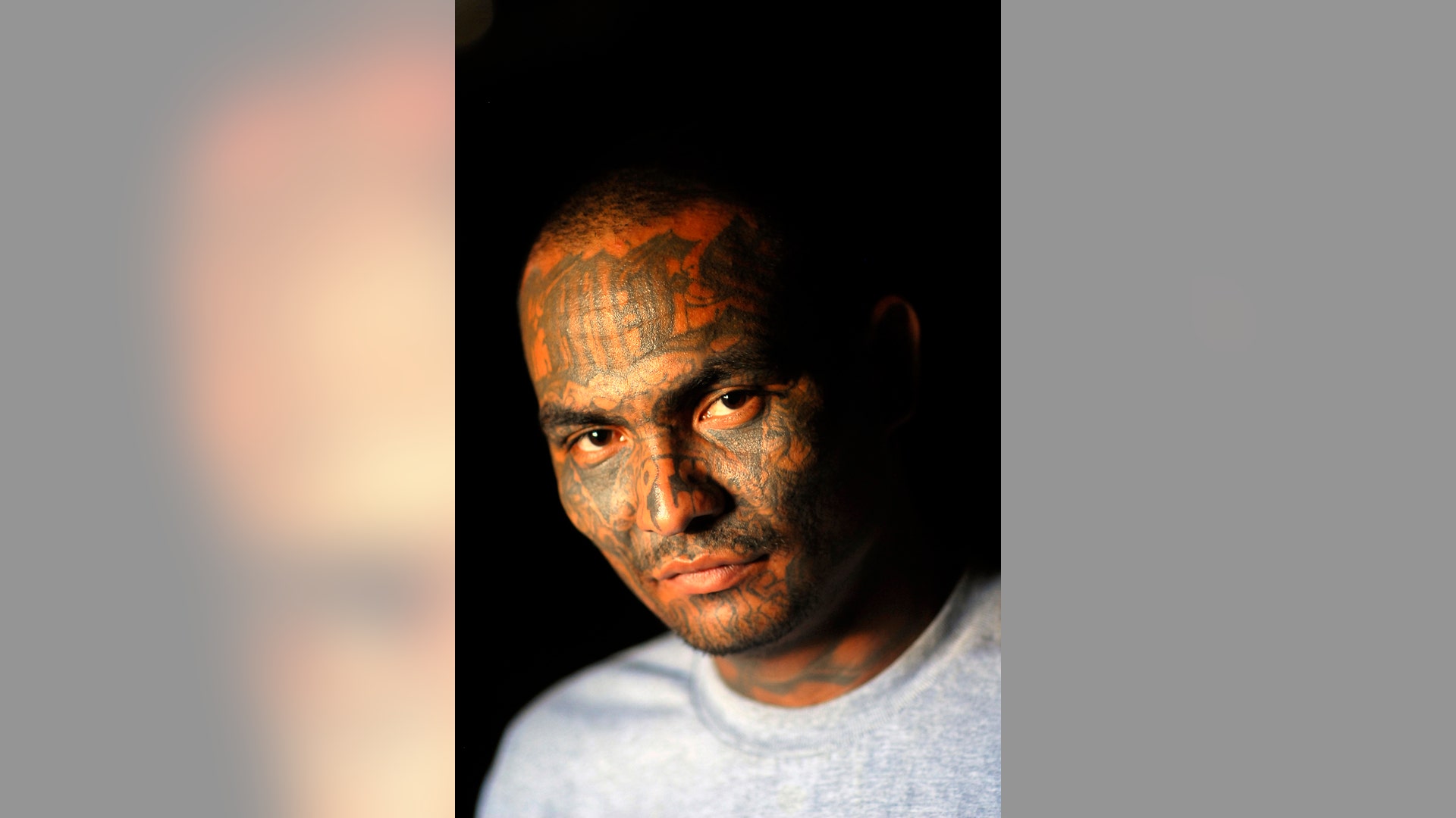 A member of the Mara Salvatrucha gang poses for a photograph at the prison of Ciudad 