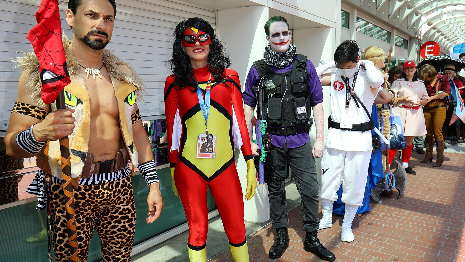 Costumed attendees wait in line to enter Comic-Con International in San Diego, California, July 21