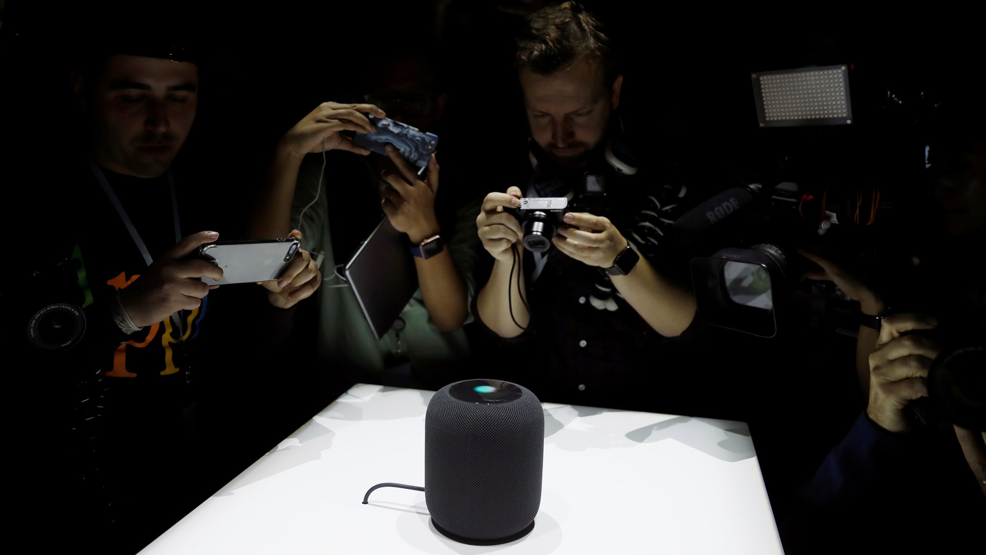 People photograph a prototype Apple HomePod during the annual Apple Worldwide Developer Conference