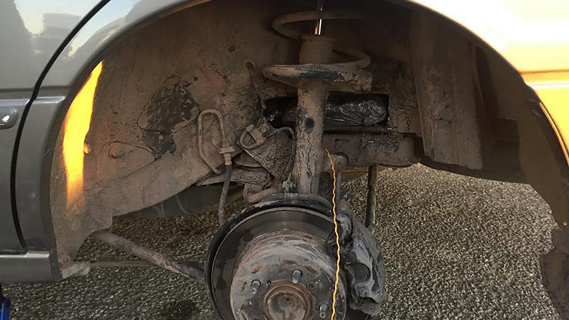 Seized drugs shown hiding in the wheel well of a car show how the Sinoloa Cartel innovted new ways to smuggle drugs