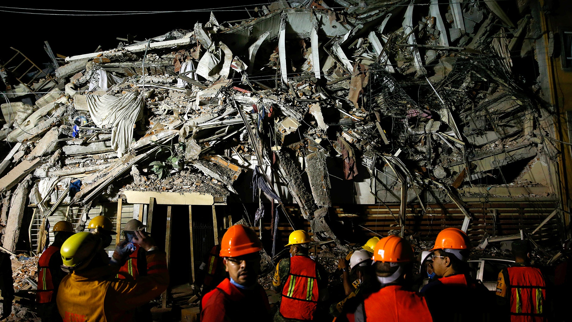 Rescuers work at the site of a collapsed building after an earthquake in Mexico City, Wednesday