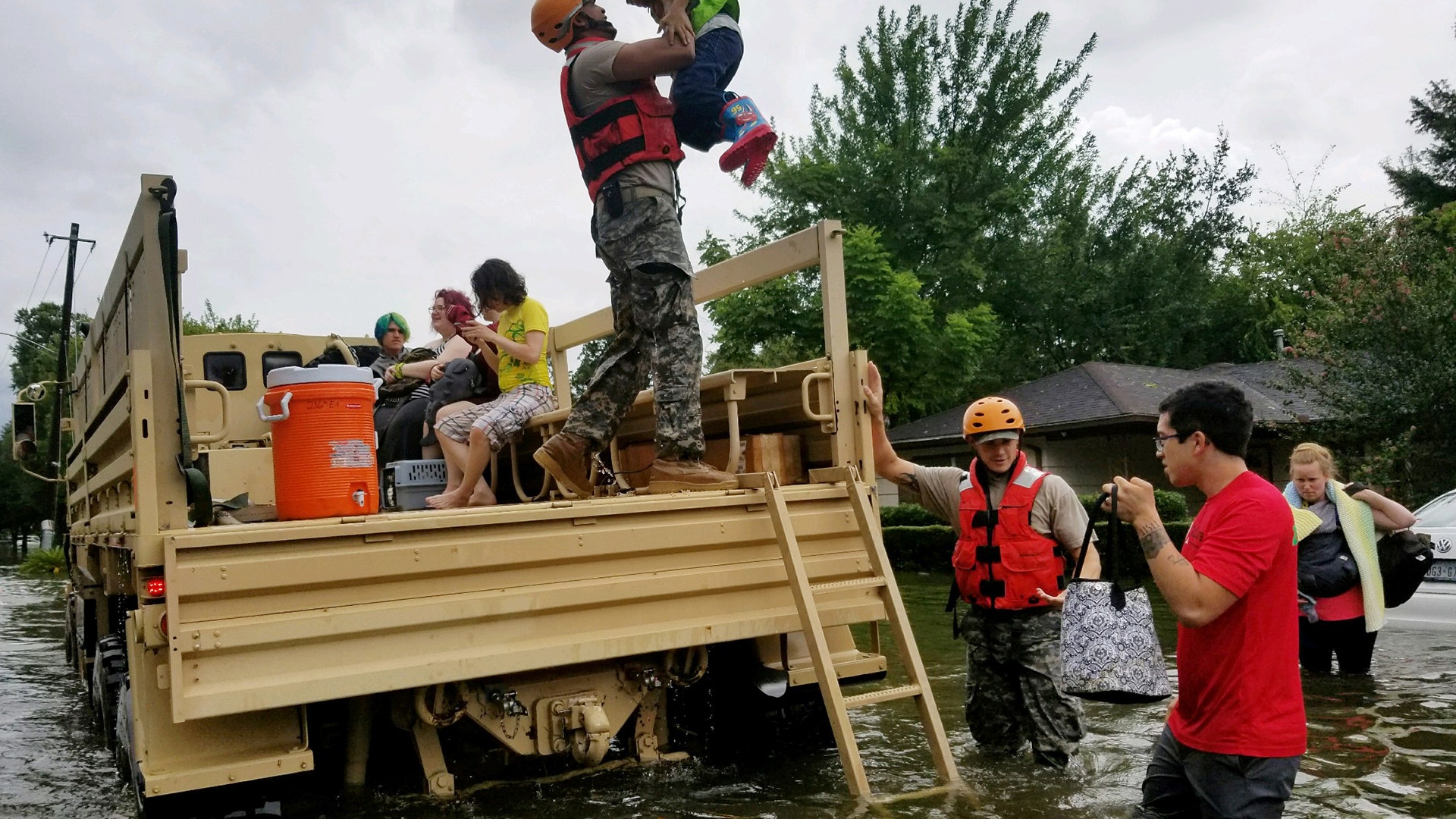 Texas National Guard soldiers aid residents in heavily flooded areas from the storms of Hurricane Harvey in Houston, Sunday