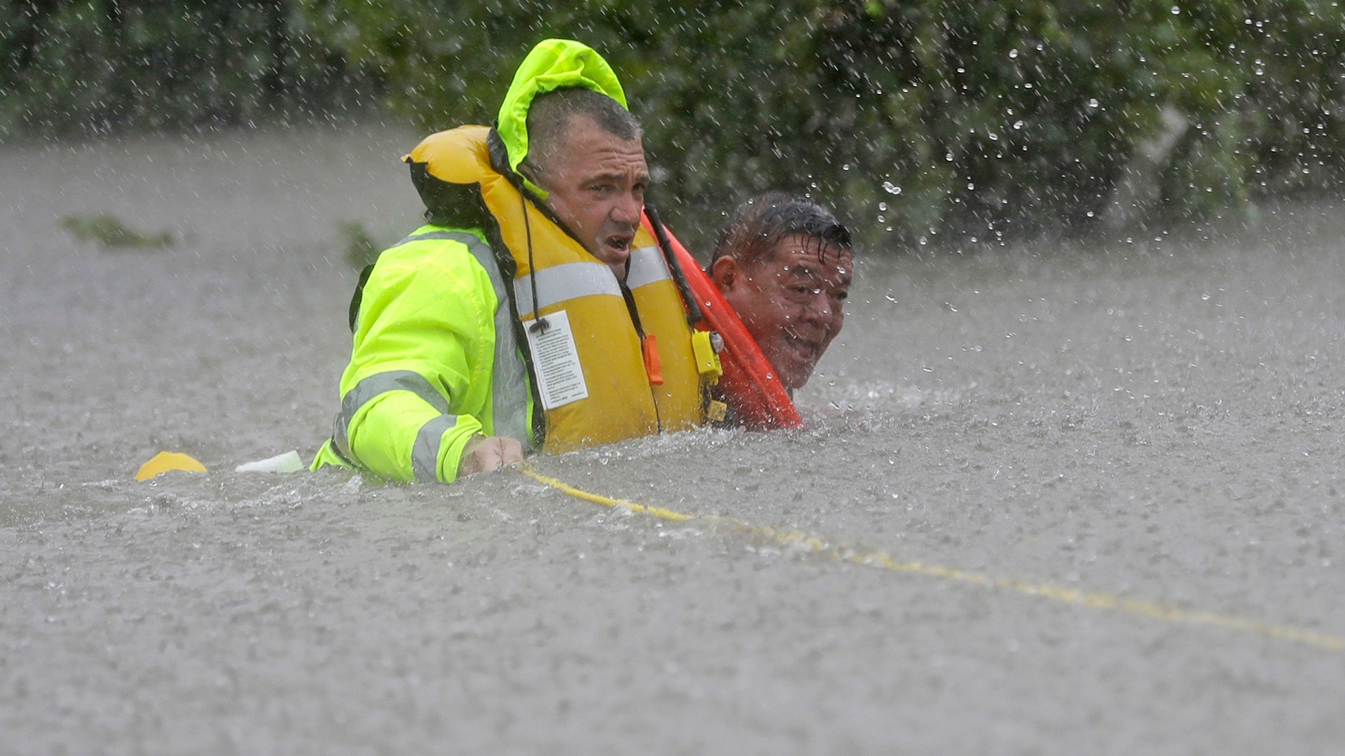 Wilford Martinez is rescued from his flooded car along Interstate 610 in floodwaters from Tropical Storm Harvey Sunday, in Houston, Texas