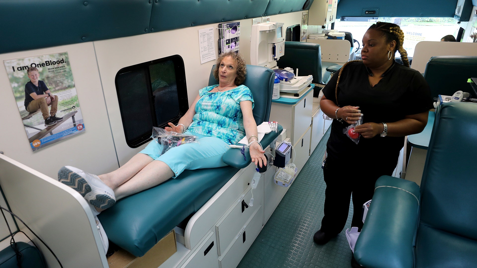 Natalie Burgess of Temple Beth Orr gives blood during an emergency blood drive in Coral Springs, Fla., Wednesday