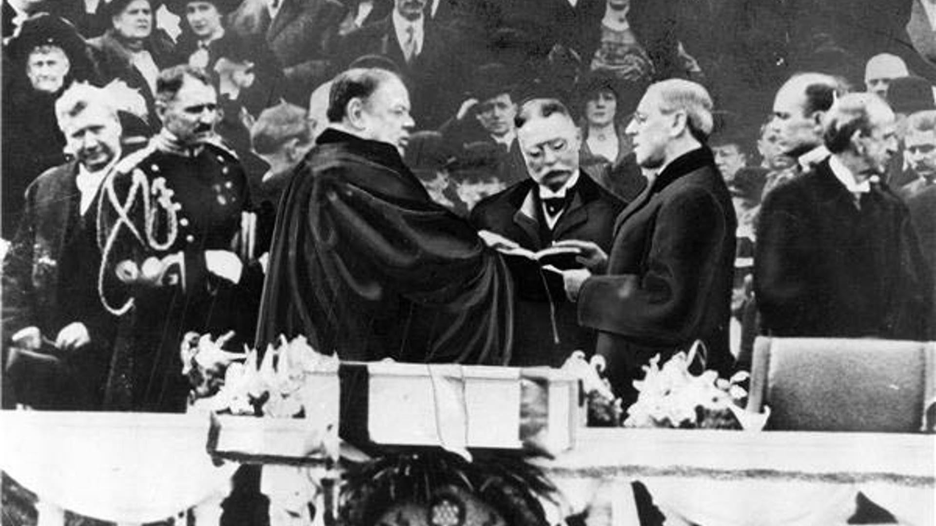 Woodrow Wilson takes the oath of office for his first term of the presidency on the East Portico at the U.S. Capitol in Washington, D.C.. Chief Justice is Edward D. White on March 4, 1913.