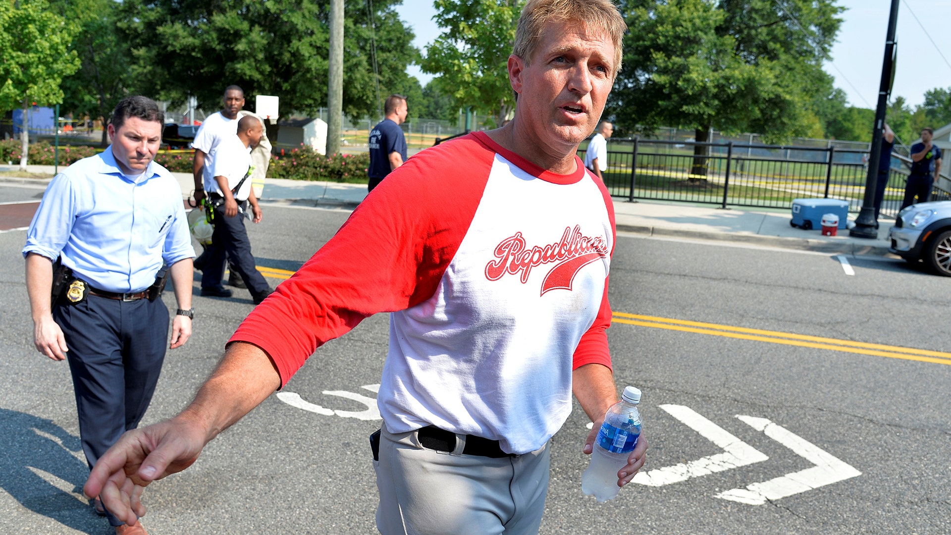 Sen. Jeff Flake (R-AZ), wearing his baseball uniform, departs the scene where shots were fired during a congressional baseball practice