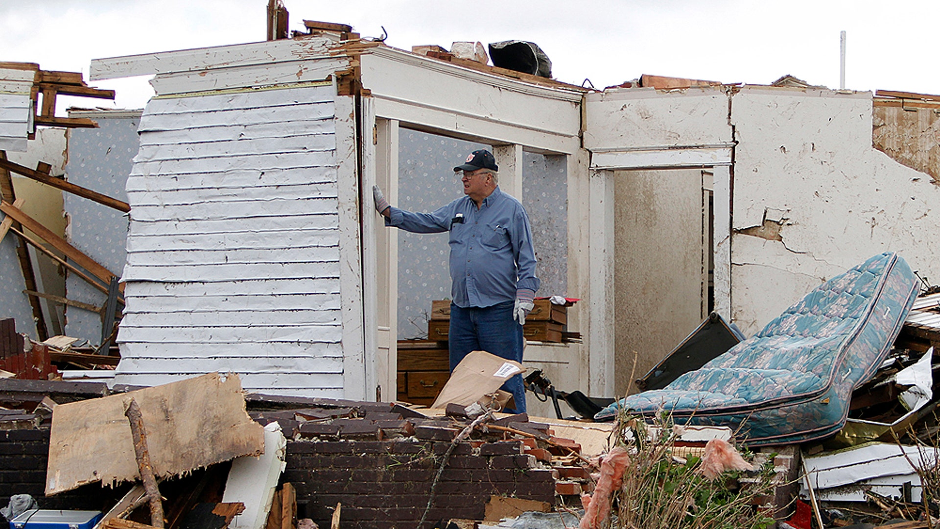 Man_Stands_in_Living_Room_Wreckage_AP