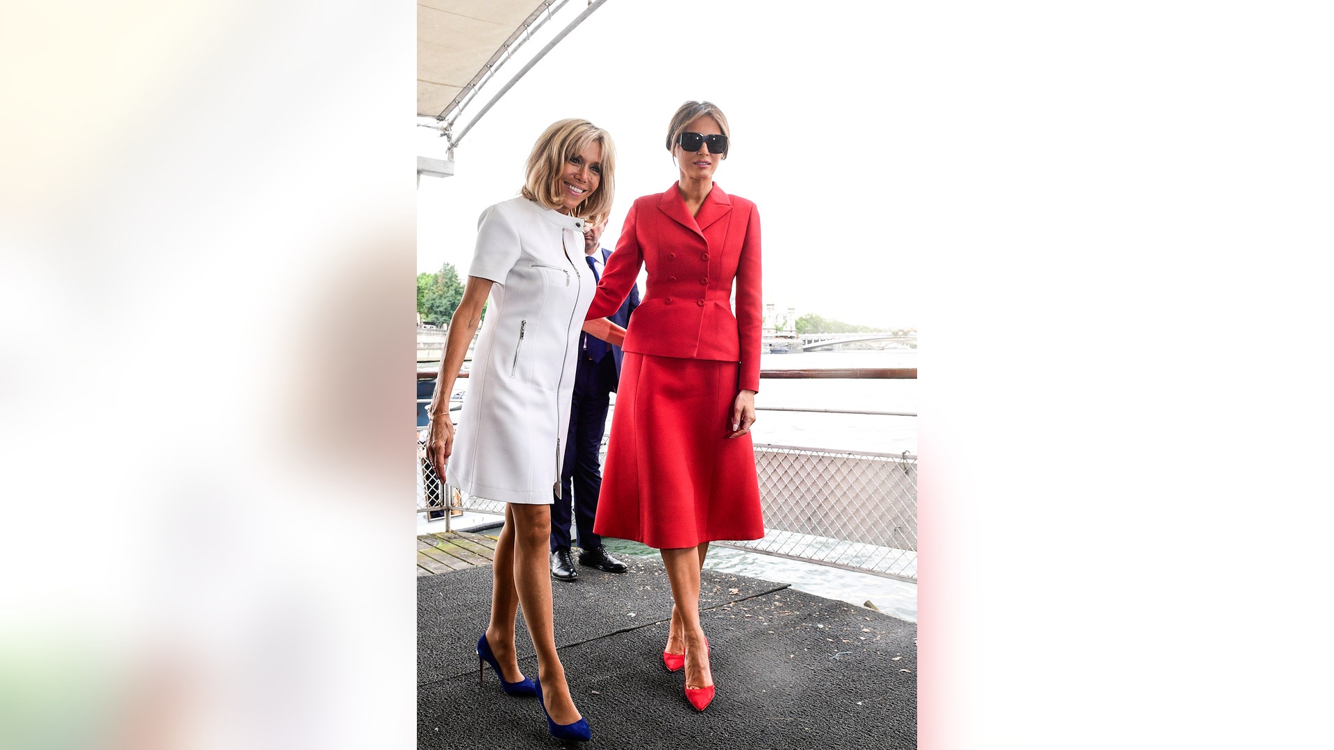 US First Lady Melania Trump and French president's wife Brigitte Macron depart after a boat trip down the River Seine in Paris