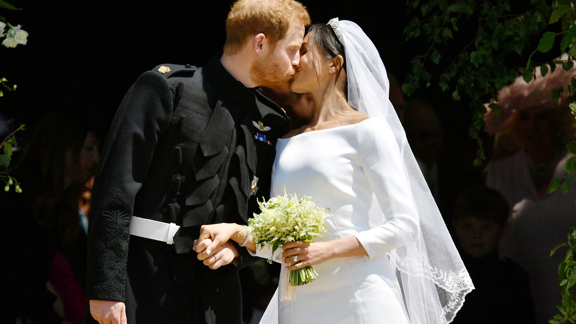 Prince Harry and Meghan Markle kiss on the steps of St George's Chapel in Windsor Castle after their wedding, May 19, 2018