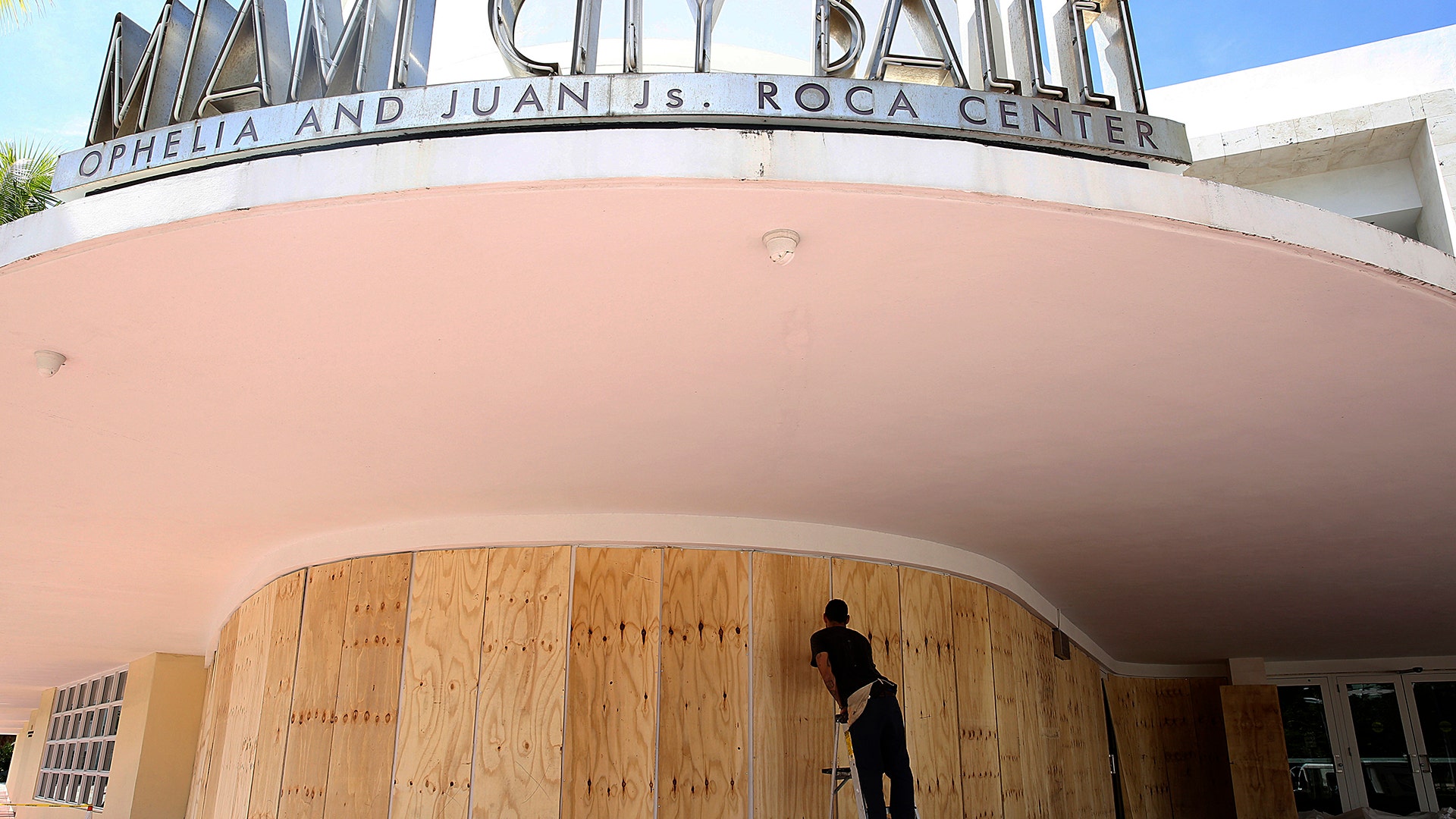 Edward Pastrana installs wood shutters at the Miami City Ballet in Miami Beach, Fla., Thursday