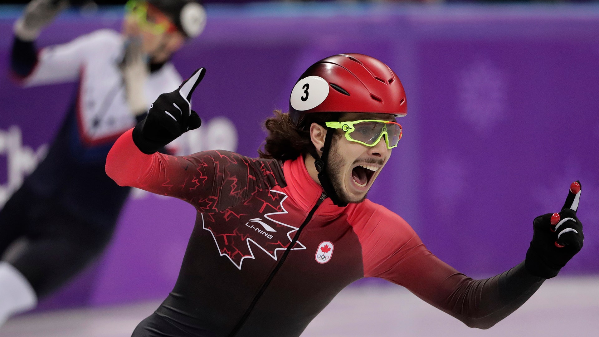 Samuel Girard of Canada celebrates at the finish line winning the gold medal in men's 1000 meters short track