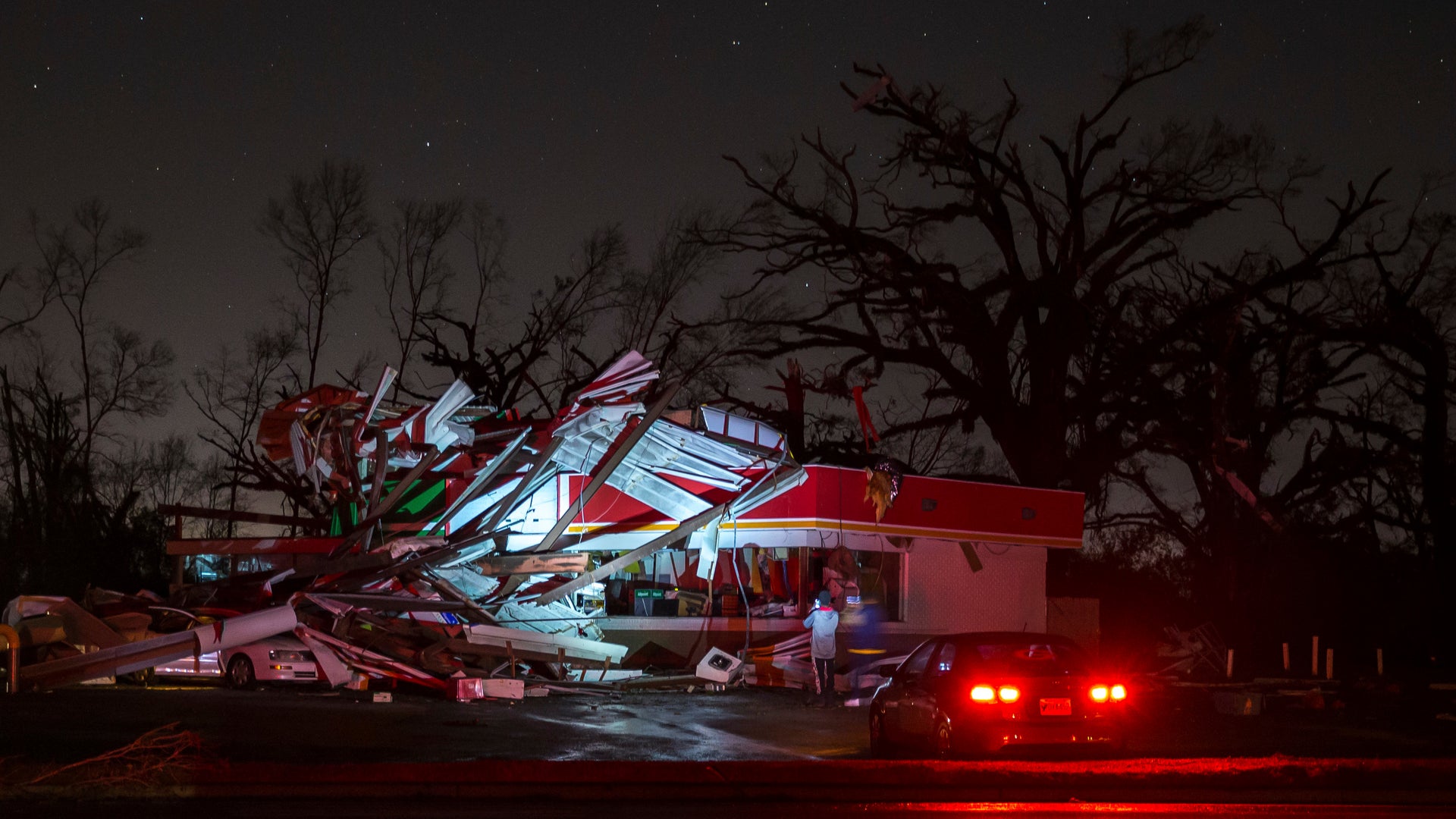 People stop to take a photo of a gas station damaged by an apparent tornado, Sunday, Jan. 22, 2017, in Albany, Ga.