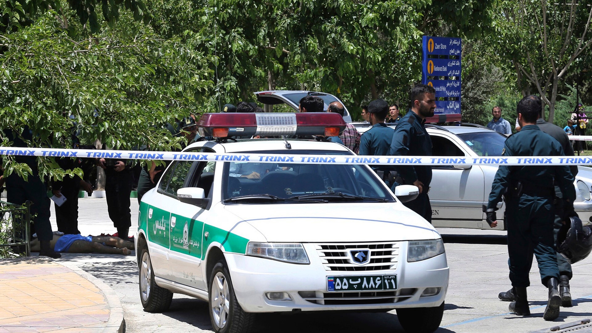 A body on the ground while police control the scene at the shine of late Iranian revolutionary founder Ayatollah Khomeini
