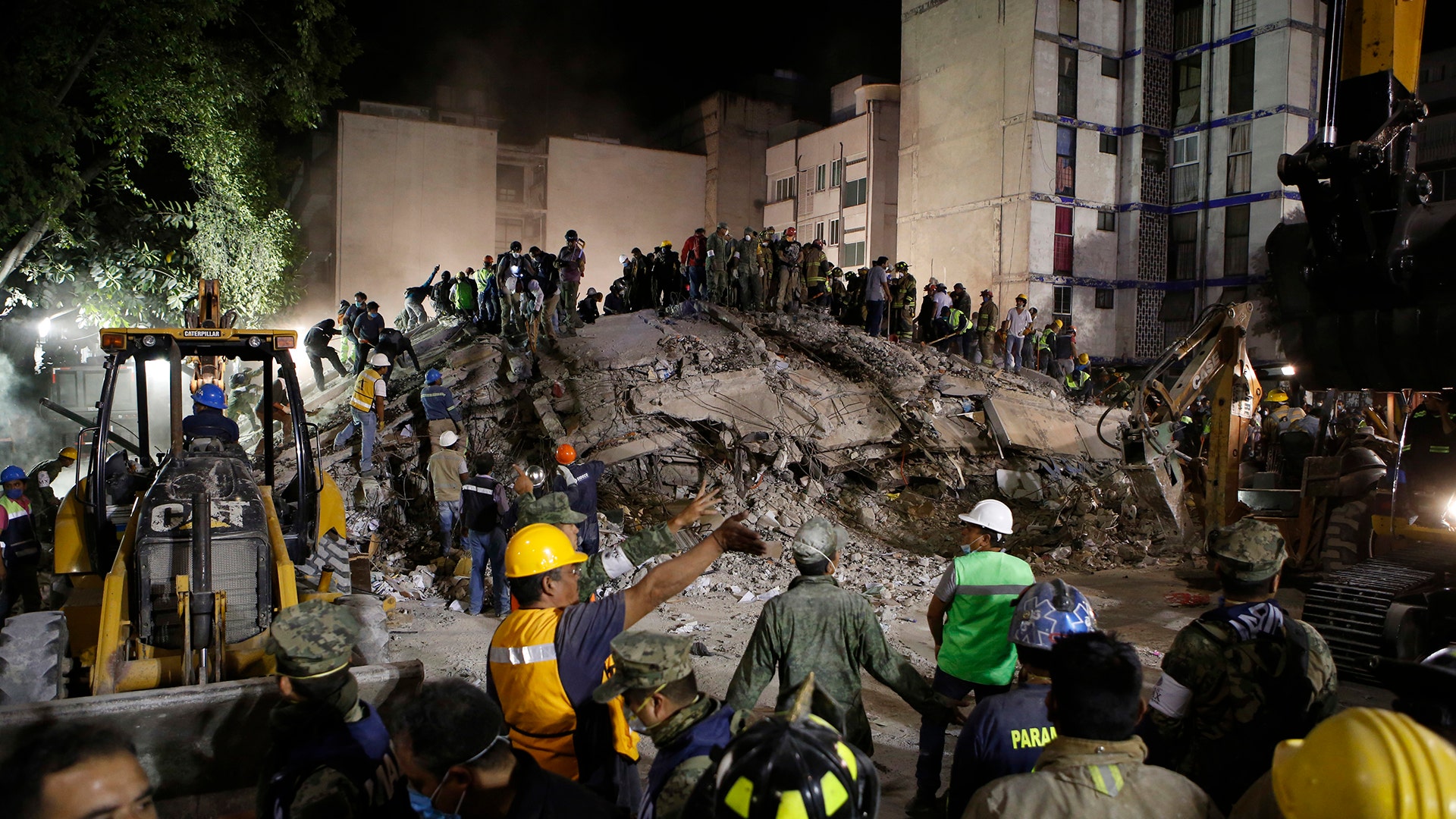 Rescue workers search for people trapped in a collapsed building in the Piedad Narvarte neighborhood of Mexico City, Tuesday