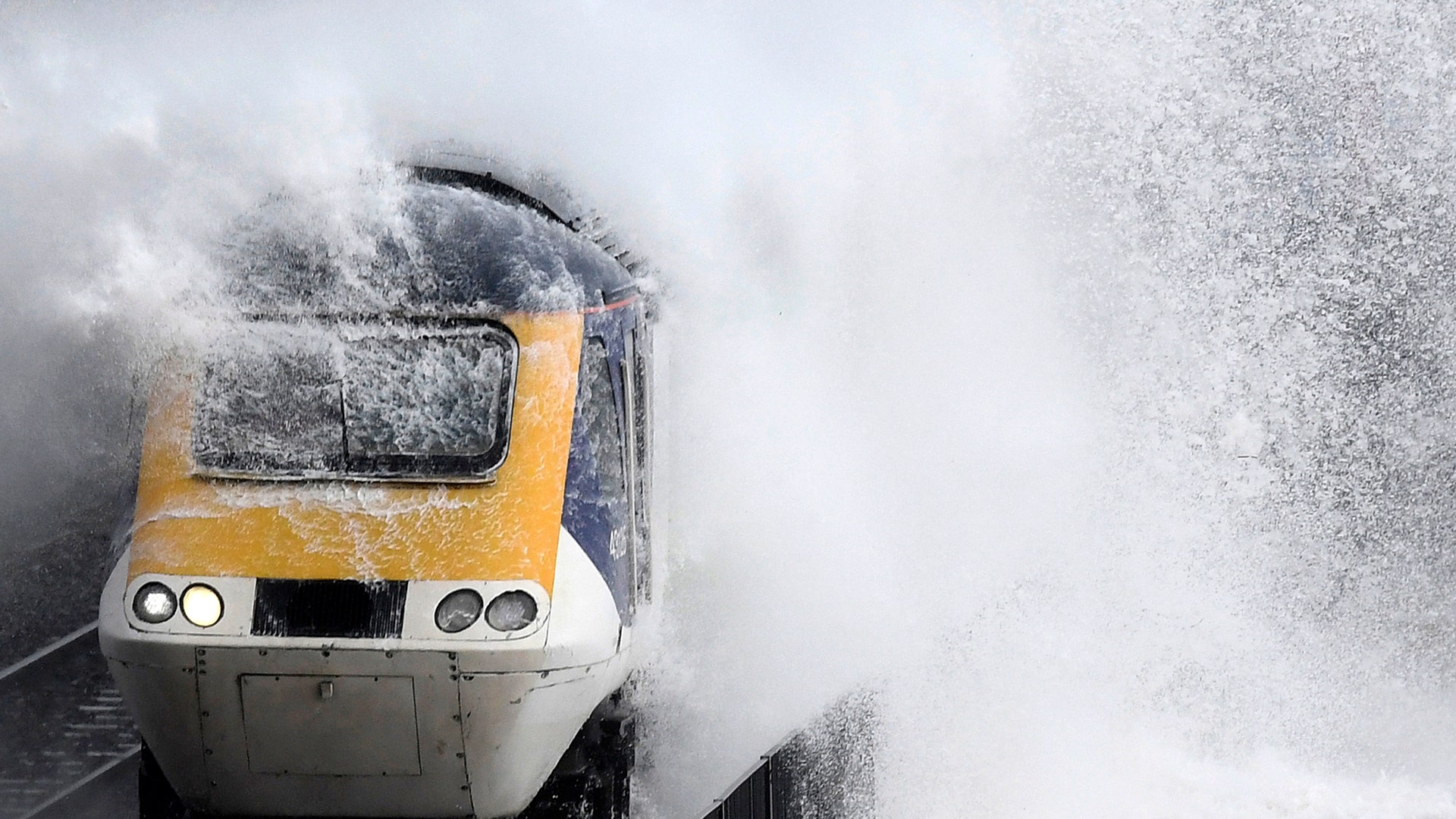 Waves hit a train during heavy seas and high winds in Dawlish in south west Britain.