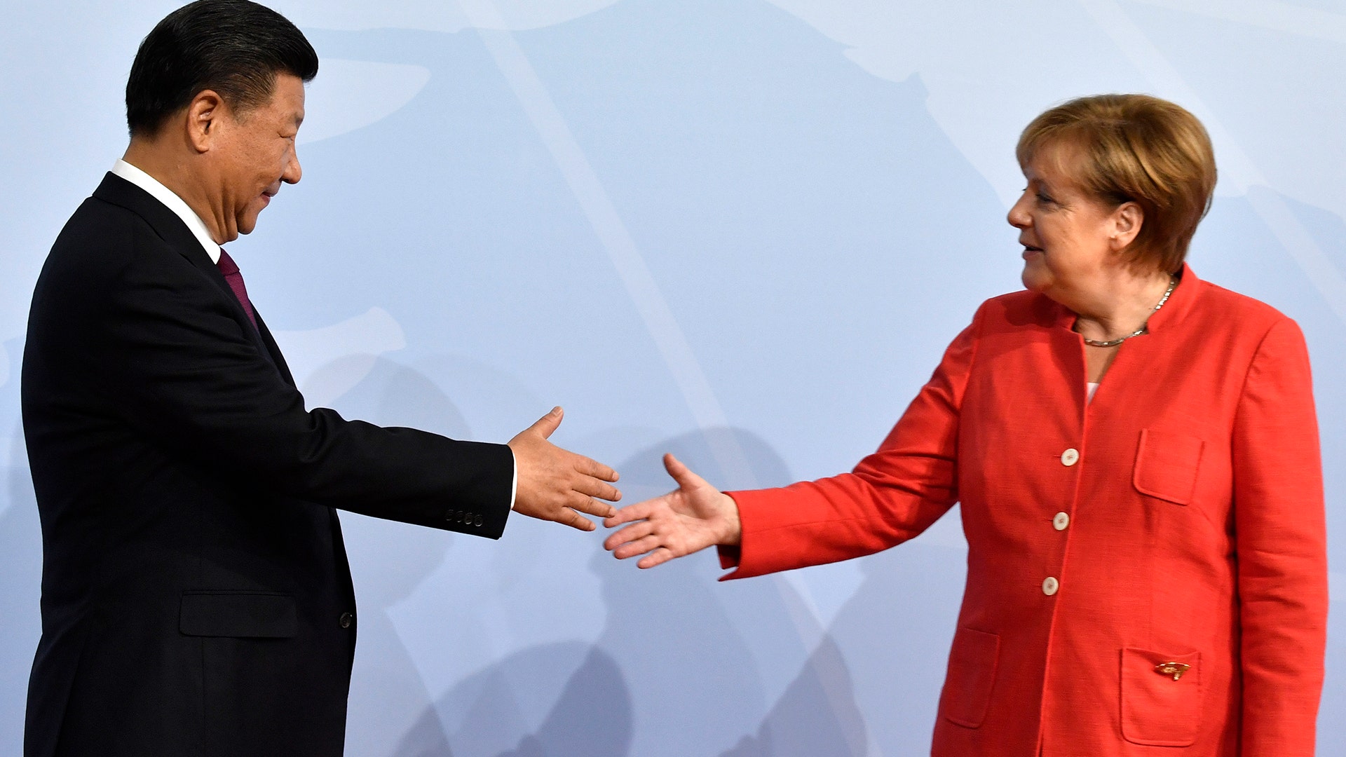 German Chancellor Angela Merkel greets China's President Xi Jinping at the start of the G-20 meeting in Hamburg, Germany