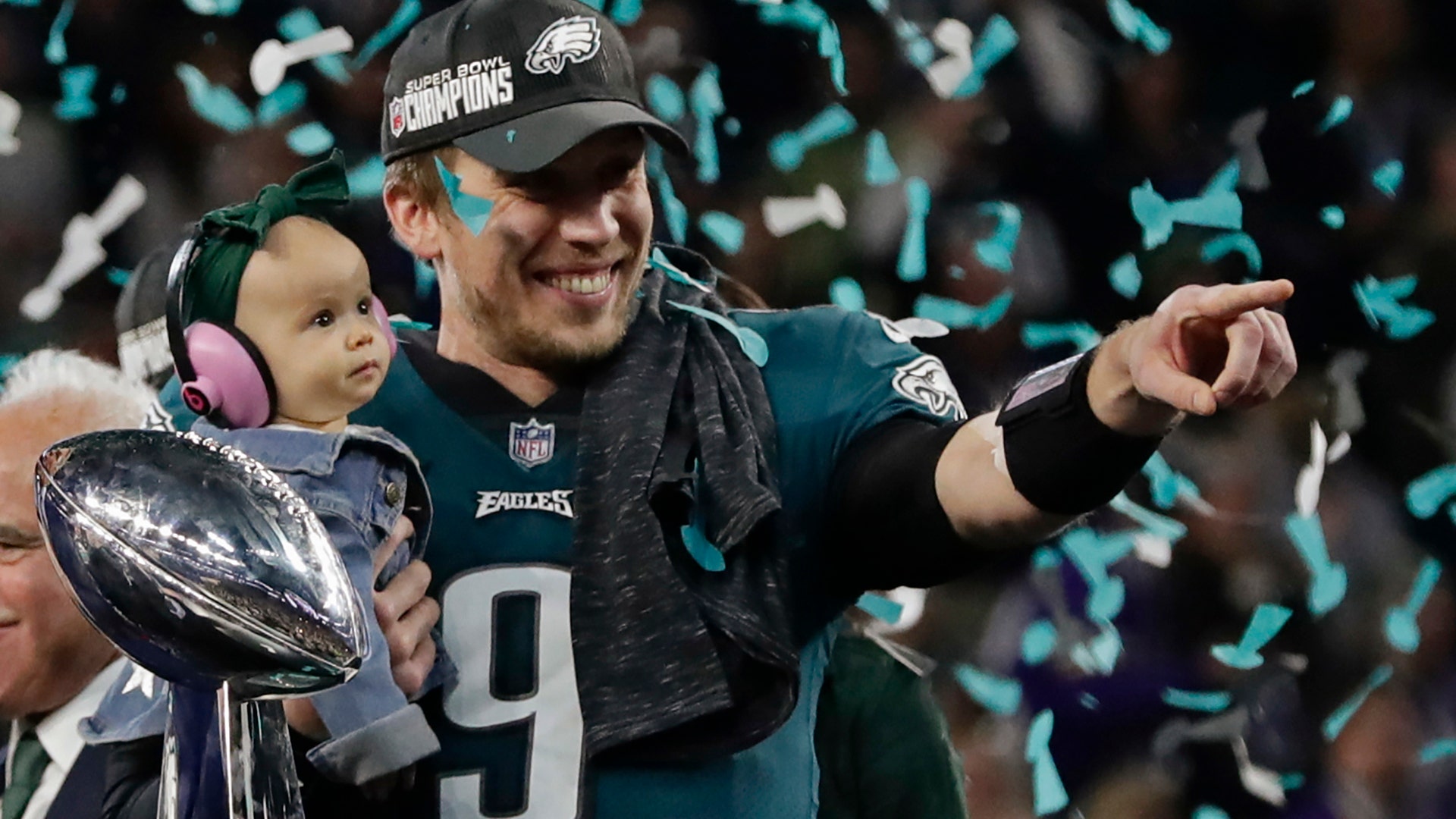 Philadelphia Eagles quarterback Nick Foles holds his daughter, Lily James, after winning Super Bowl 52 in Minneapolis, February 4