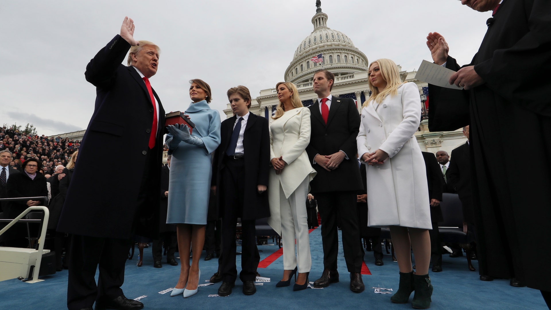 President Donald Trump takes the oath of office from Chief Justice John Roberts, as his wife Melania holds the bible.