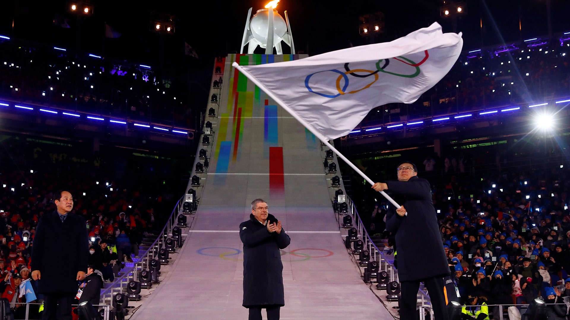 Beijing mayor Chen Jining, host city for the 2022 Winter Olympics, waves the Olympic flag during the 2018 Winter Olympics in Pyeongchang