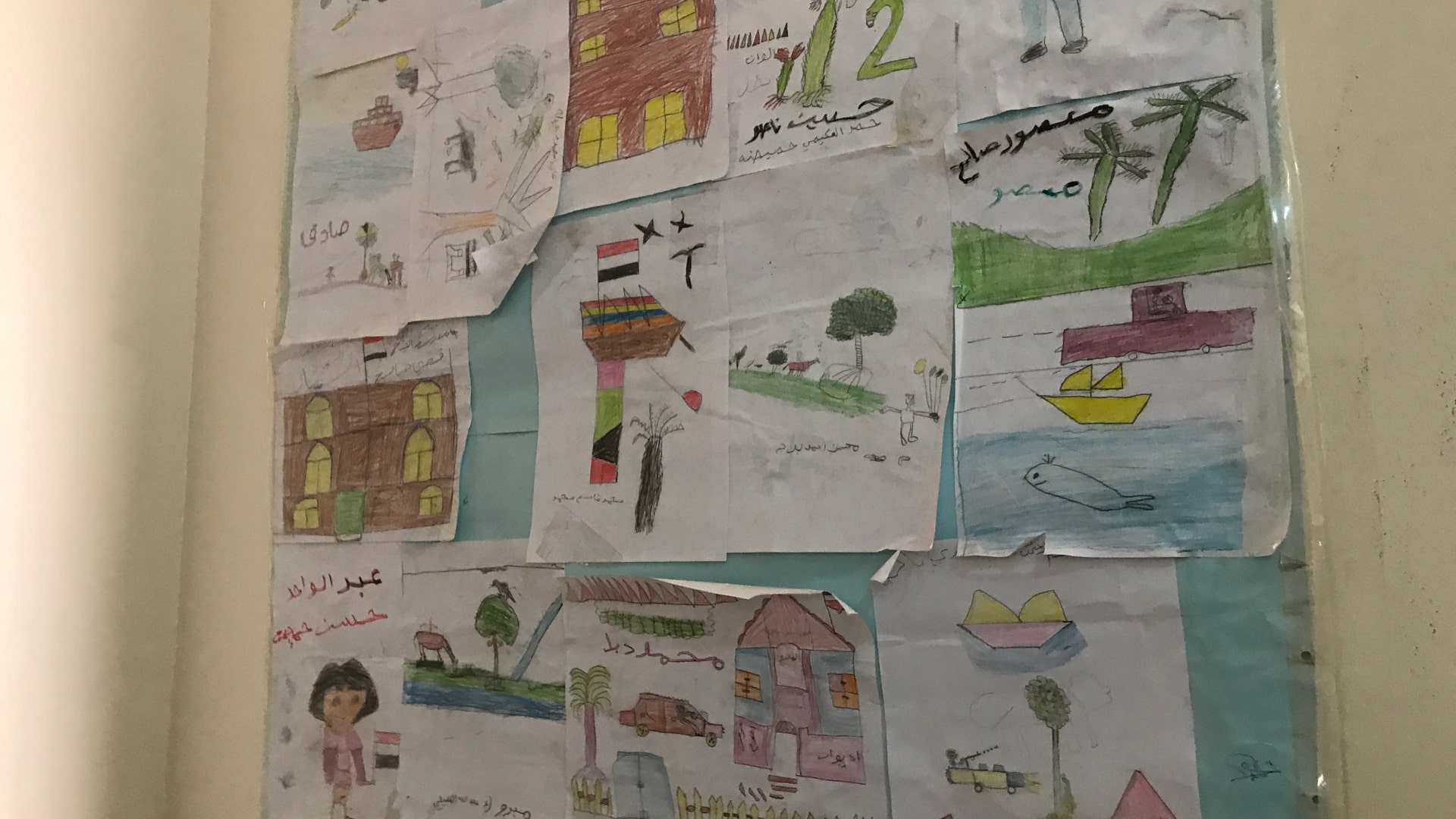 Children's artwork is displayed on the walls inside the KS Relief Center.