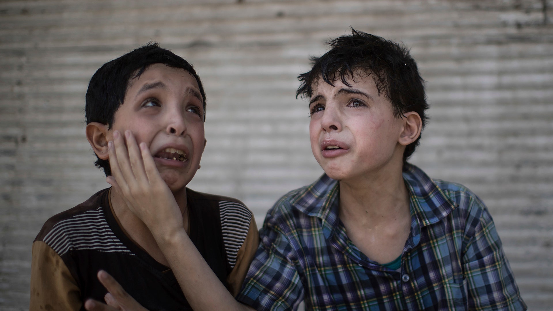 Zeid Ali, left, and Hodayfa 11, after their house was hit in fighting between Iraqi forces and Islamic State militants in Mosul, Iraq, June 24, 2017