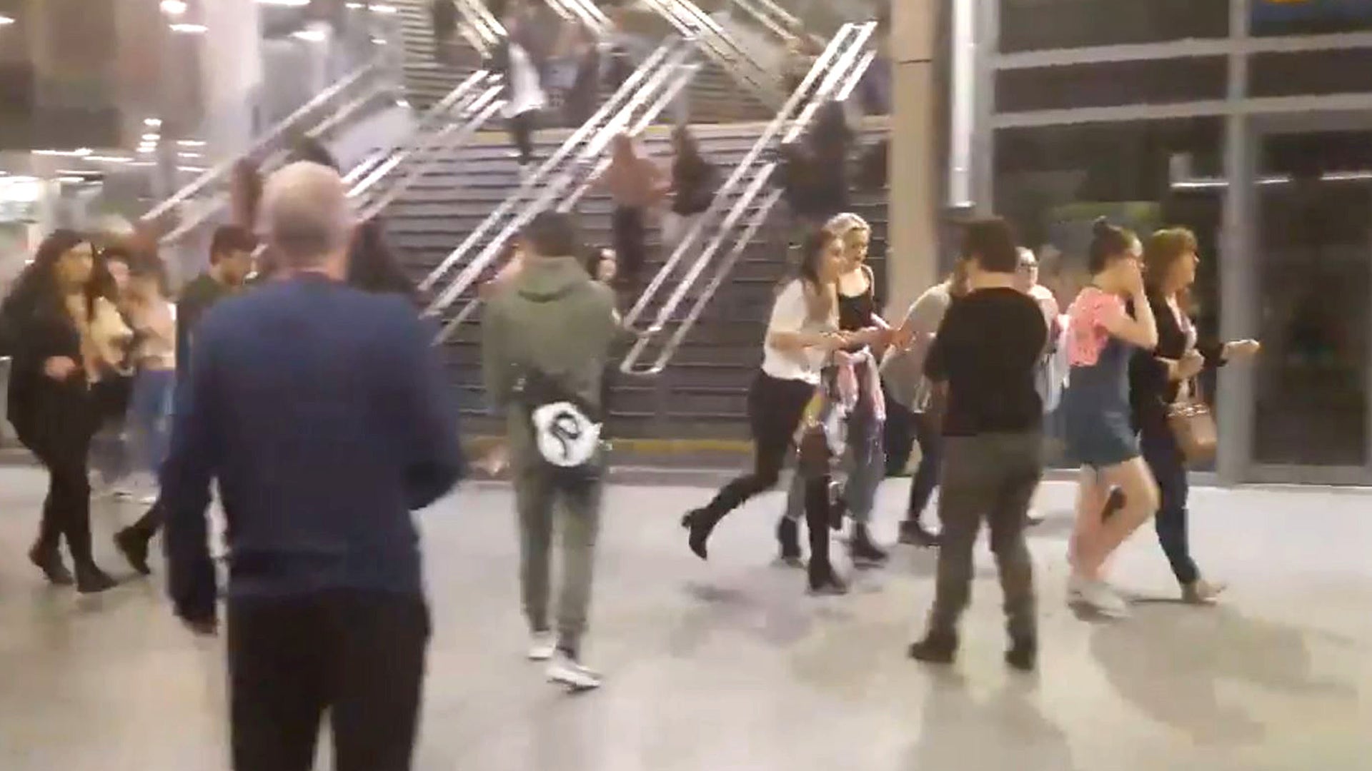 People running through Manchester Victoria station after an explosion at Manchester Arena in Manchester during a concert by Ariana Grande.