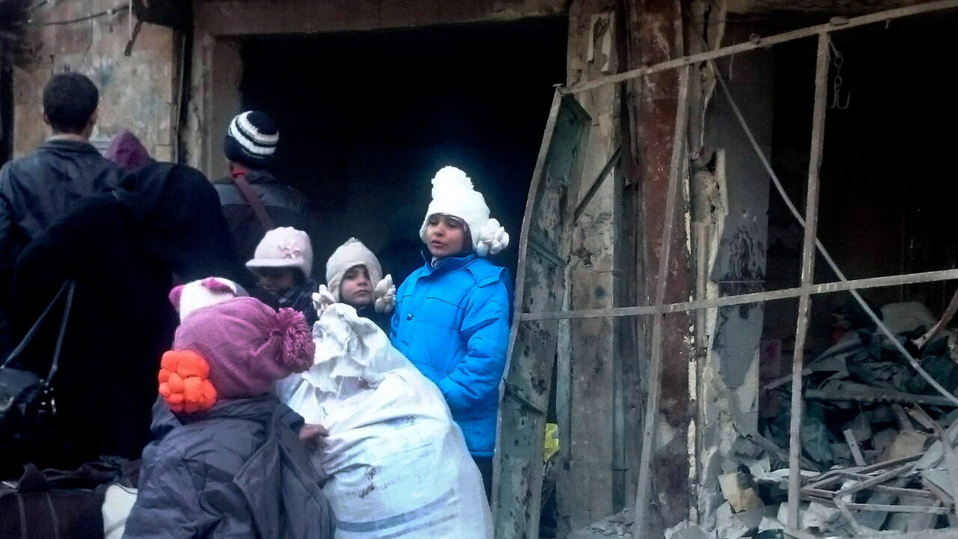 Eastern Aleppo residents wait in the streets to be evacuated from the war-torn city of Aleppo, Syria, Thursday, Dec. 15, 2016. 
