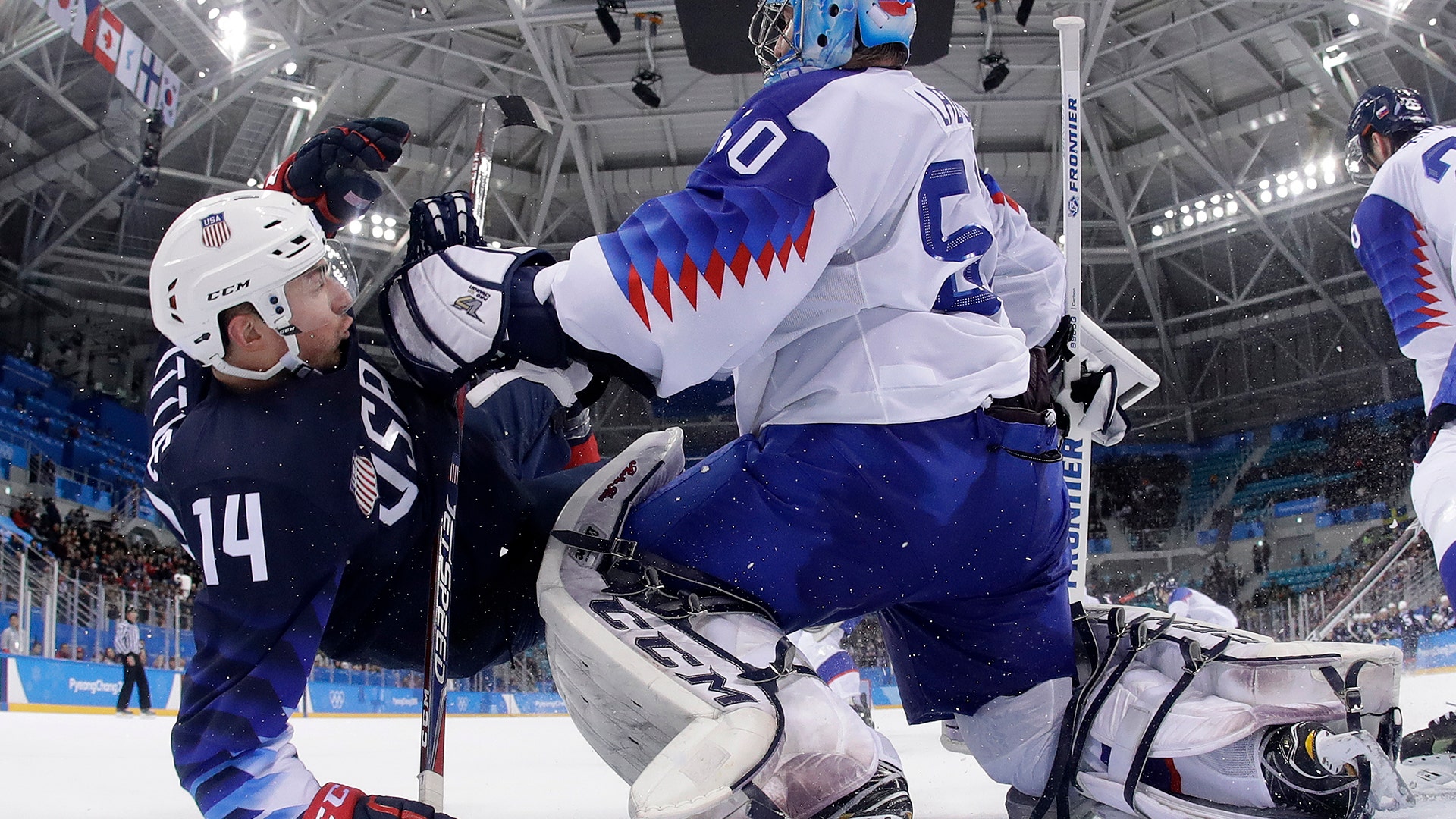 Goalie Jan Laco of Slovakia, pushes Broc Little of the United States during their men's ice hockey game at the 2018 Winter Olympics