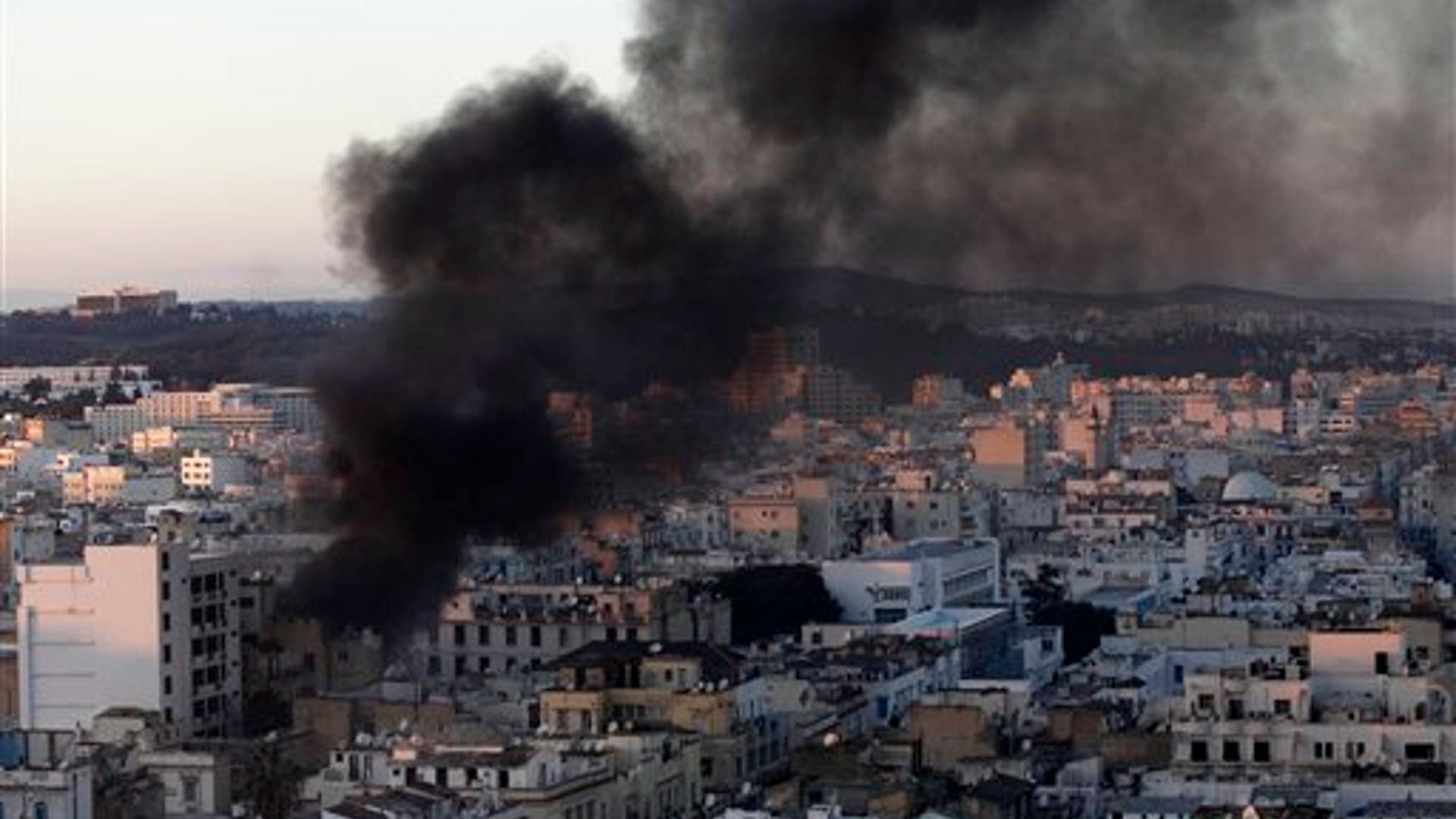 A_column_of_smoke_rises_from_buildings_during_clashes