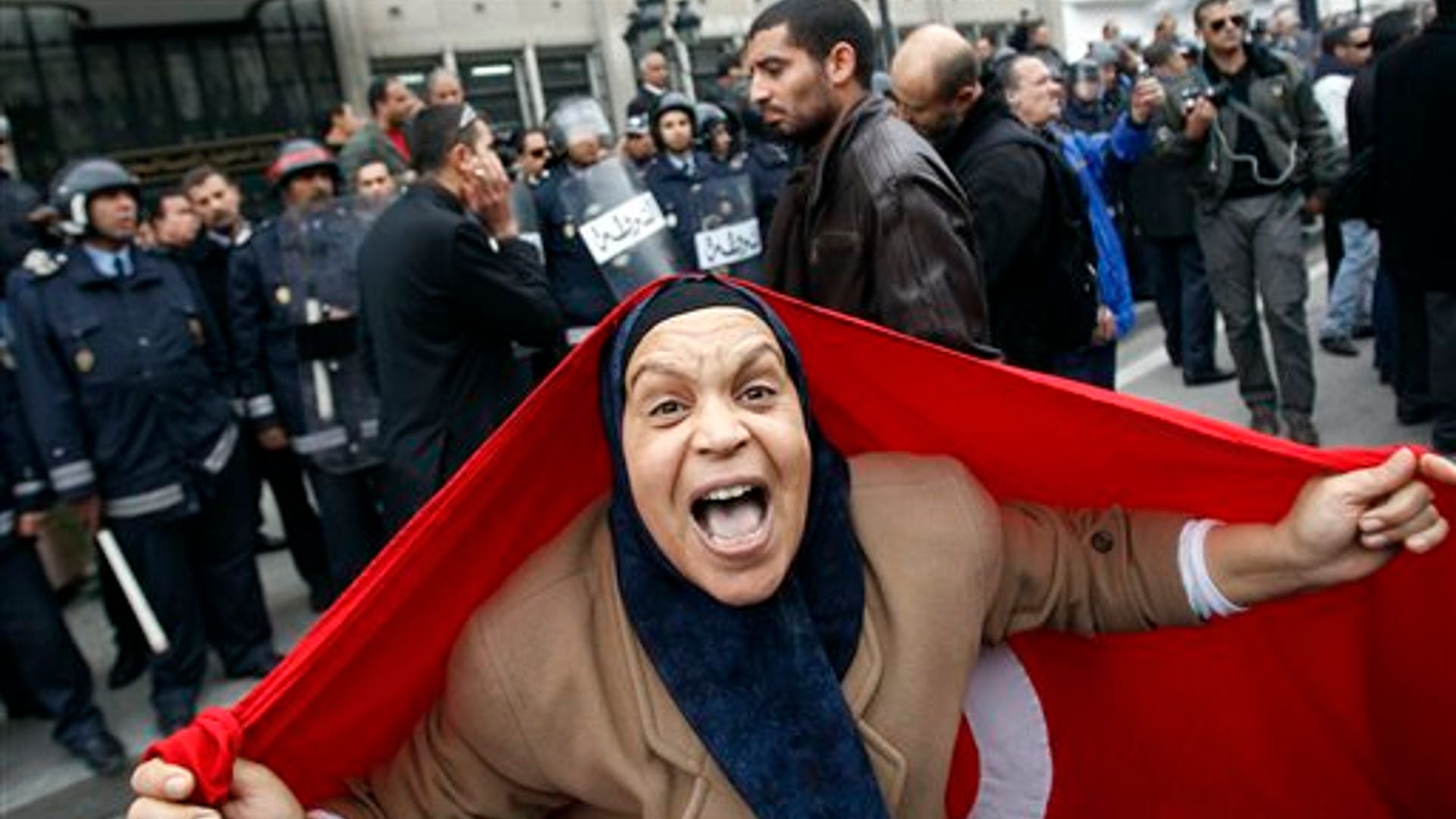 A_protester_with_a_Tunisian_flag_shouts_slogans
