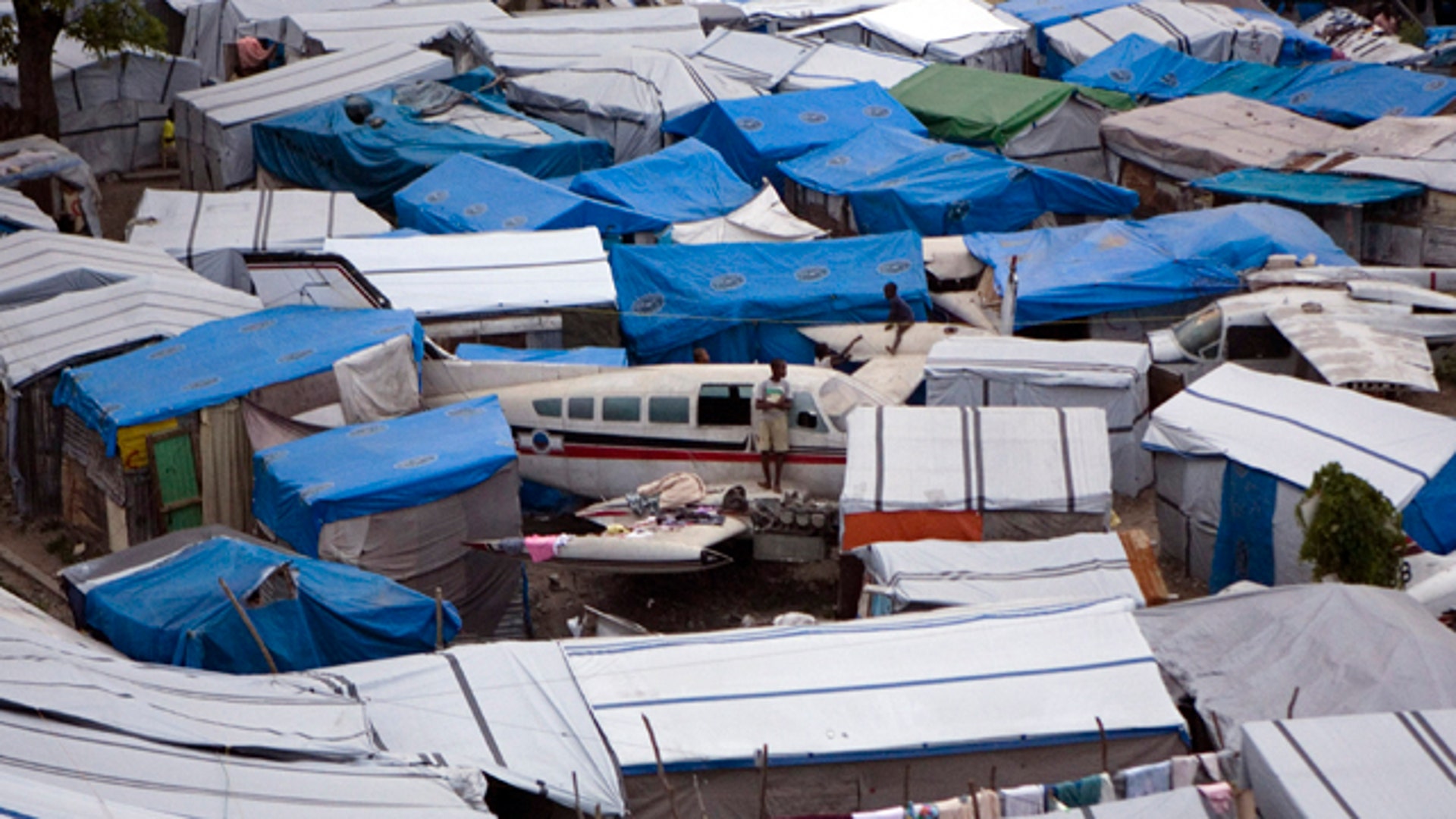 A Boy Leans on an Aircraft in the Survivor Camp