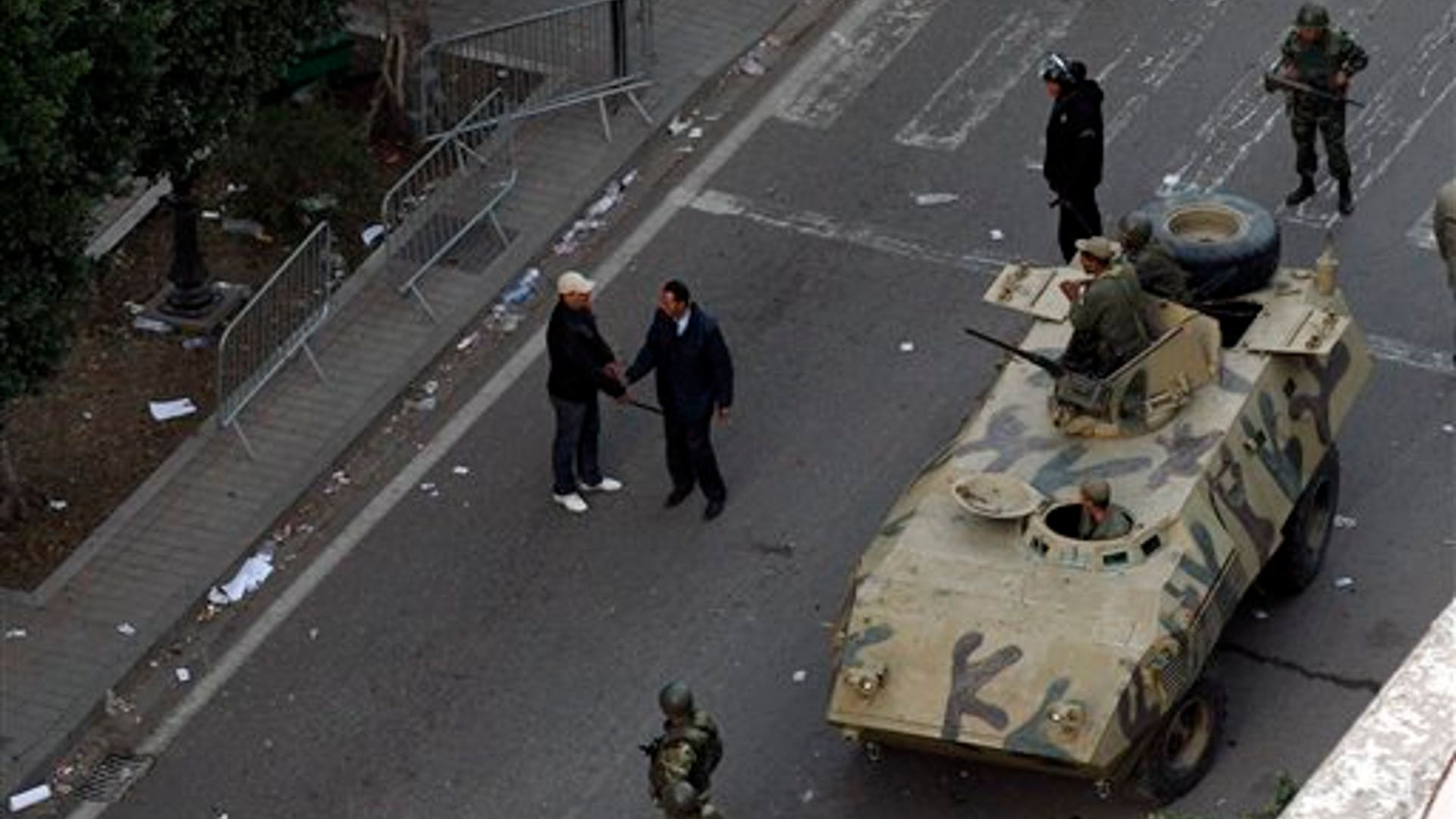 An_armored_vehicle_patrols_a_street_in_Tunis_during_clashes