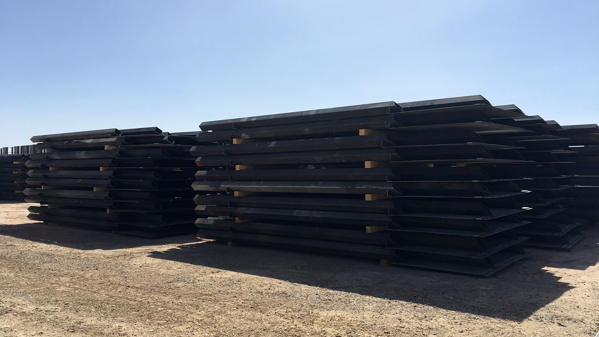  Stacks of steel bollard fencing are ready to be placed at the border