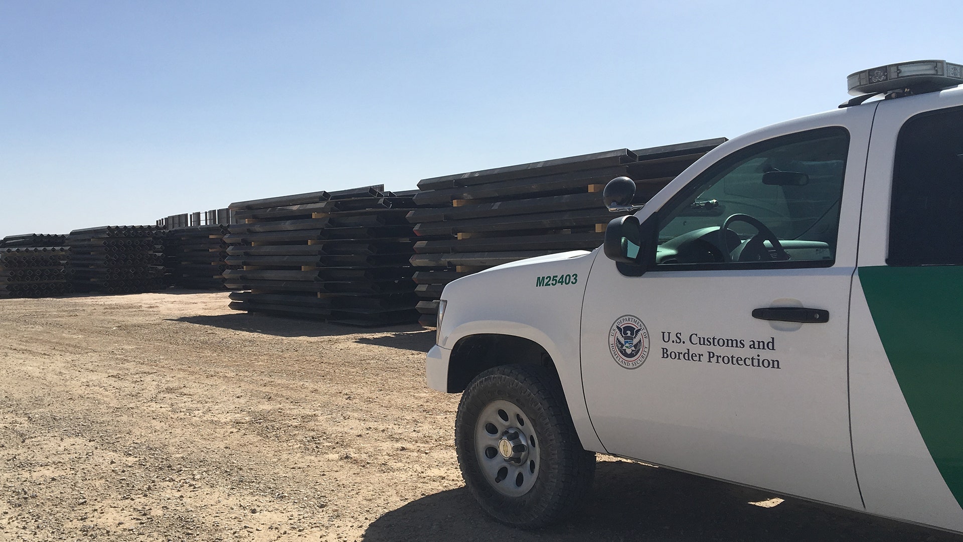 The yard where stacks of steel bollard fencing for the border are being staged