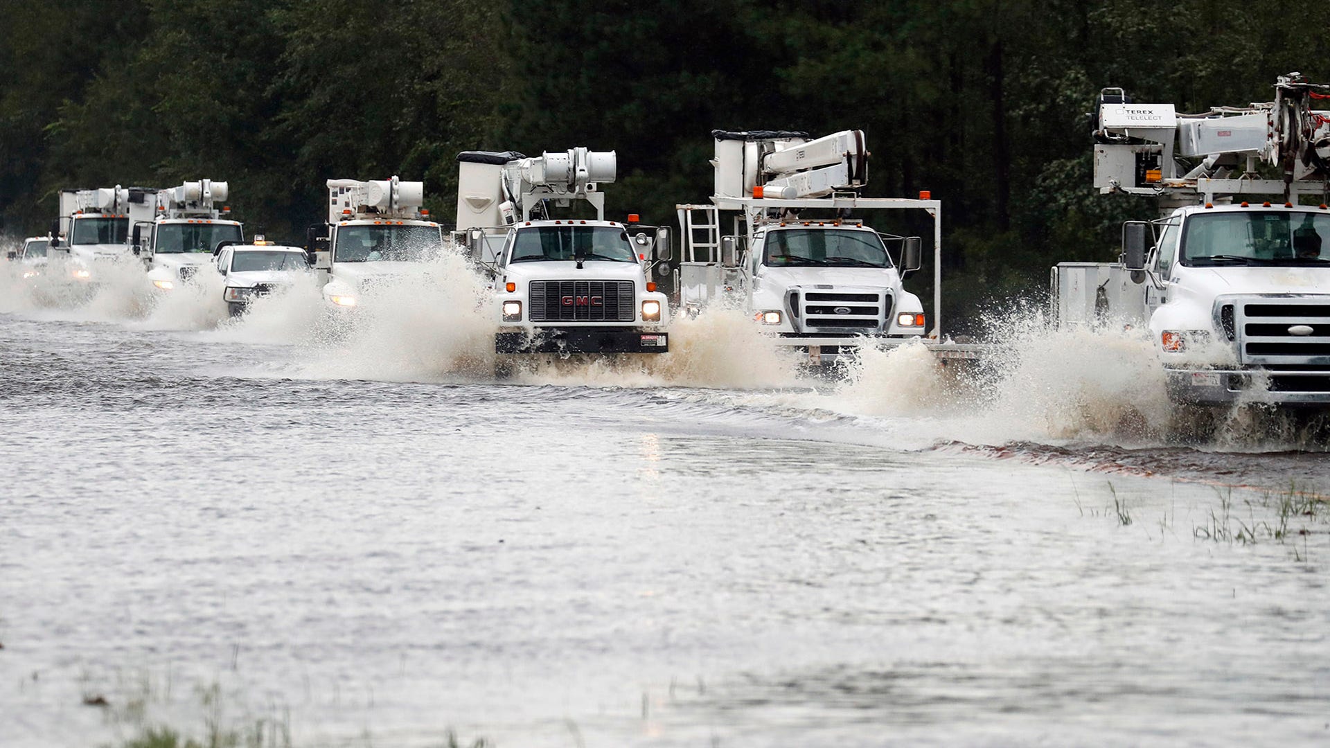 A convoy of utility trucks to assist with damage caused by Florence makes its way through Hwy 70 east of Kinston, Saturday