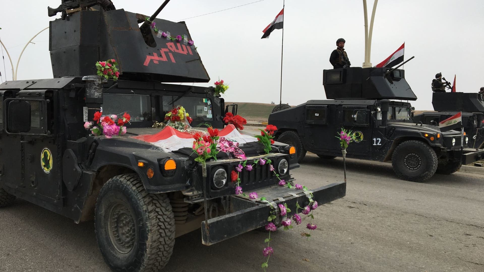 Armored car joins a parade celebrating the liberation of the eastern section of Mosul.
