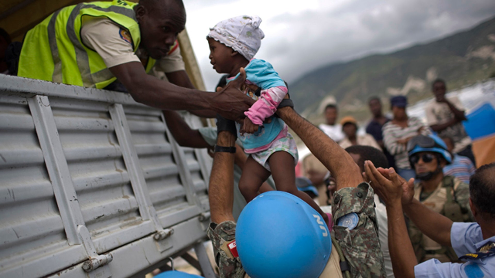U.N. Soldiers Help Evacuate a Little Girl